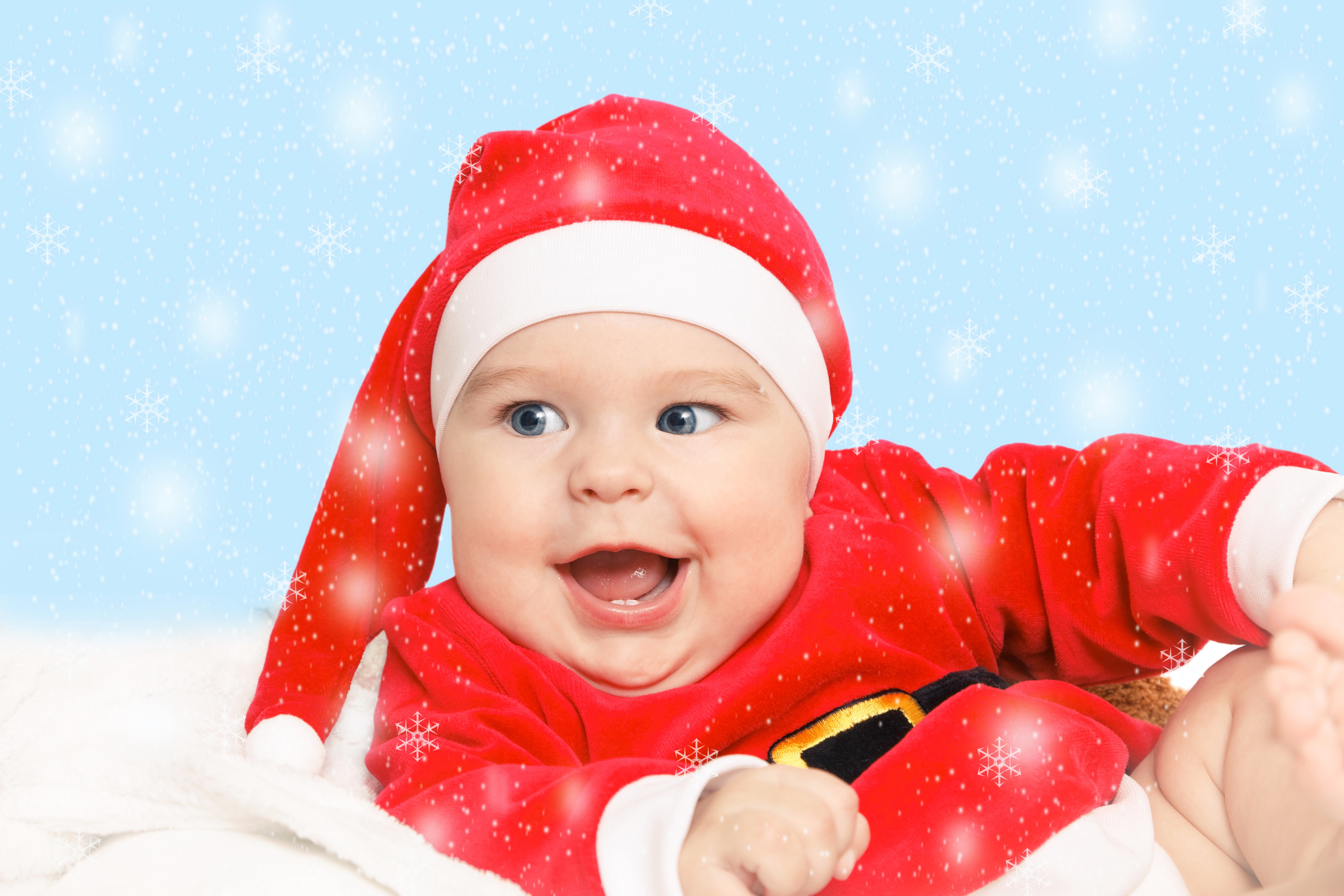 Baby in Santa hat and costume with snowflakes HD Wallpaper