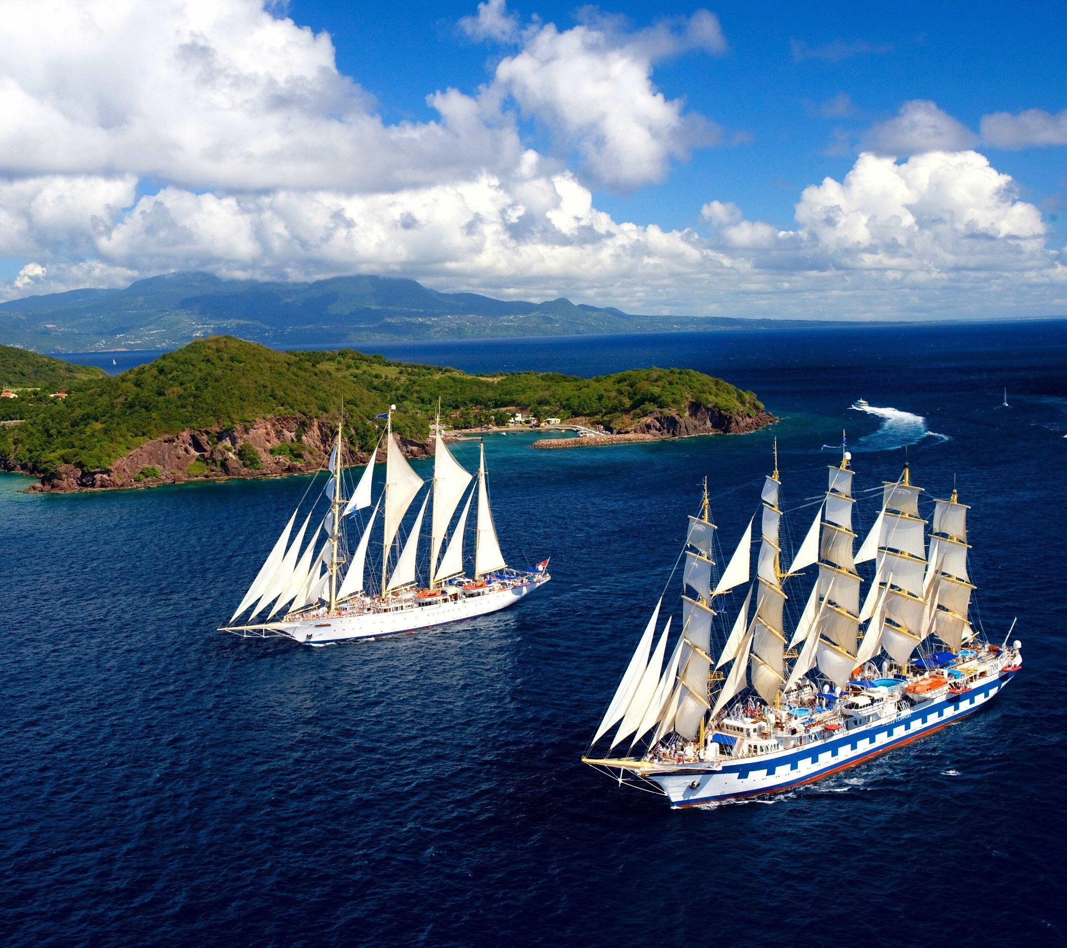Two large sailing ships on the ocean near islands HD Wallpaper