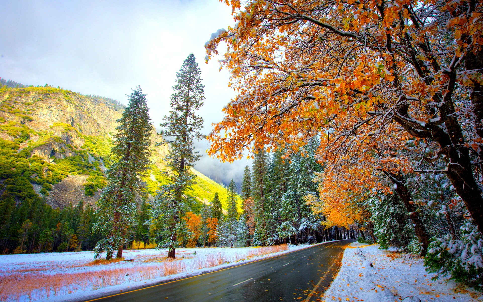 Road through a snowy mountain landscape in autumn HD Wallpaper