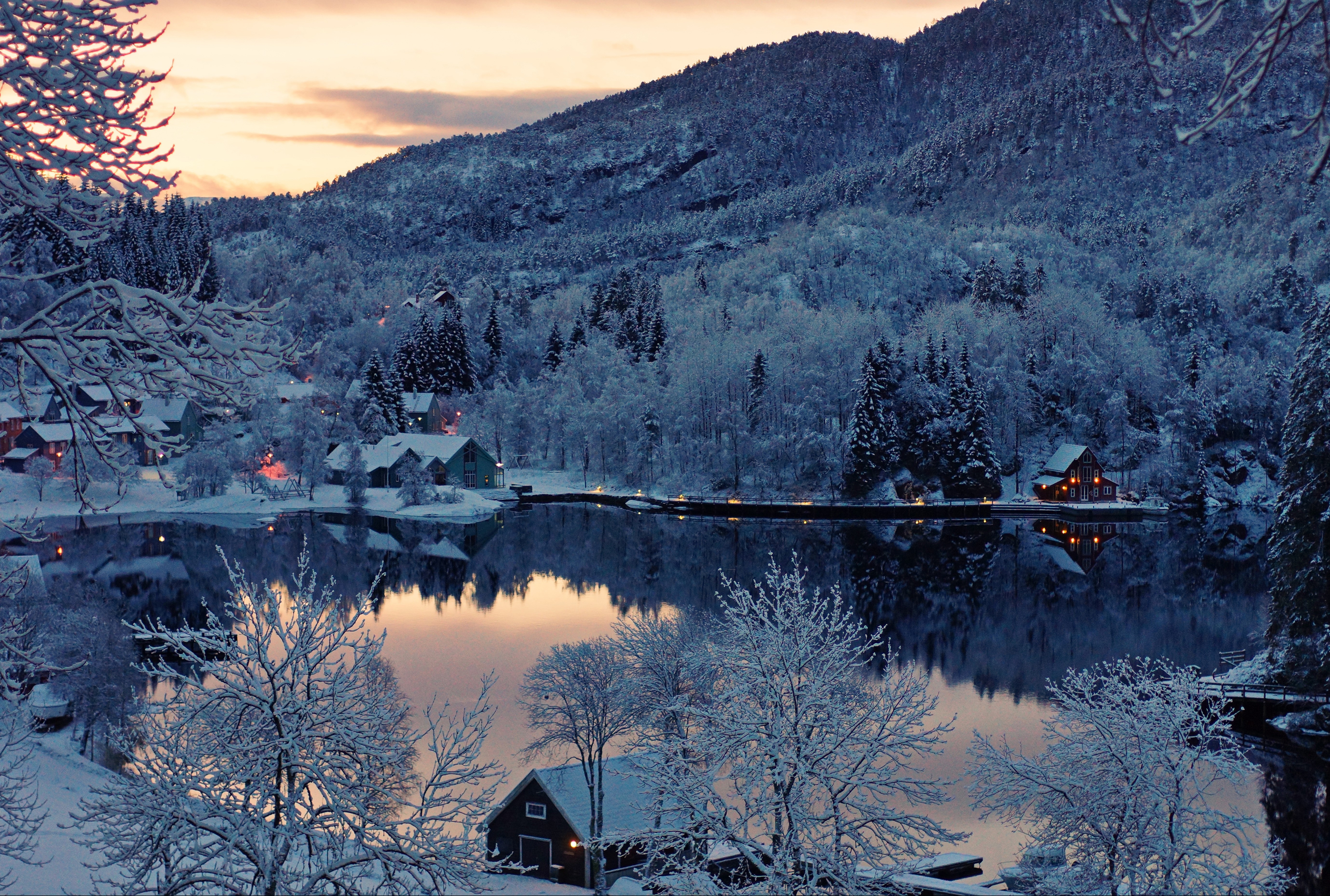 Winter scene with snow-covered houses by a lake in Finland HD Wallpaper