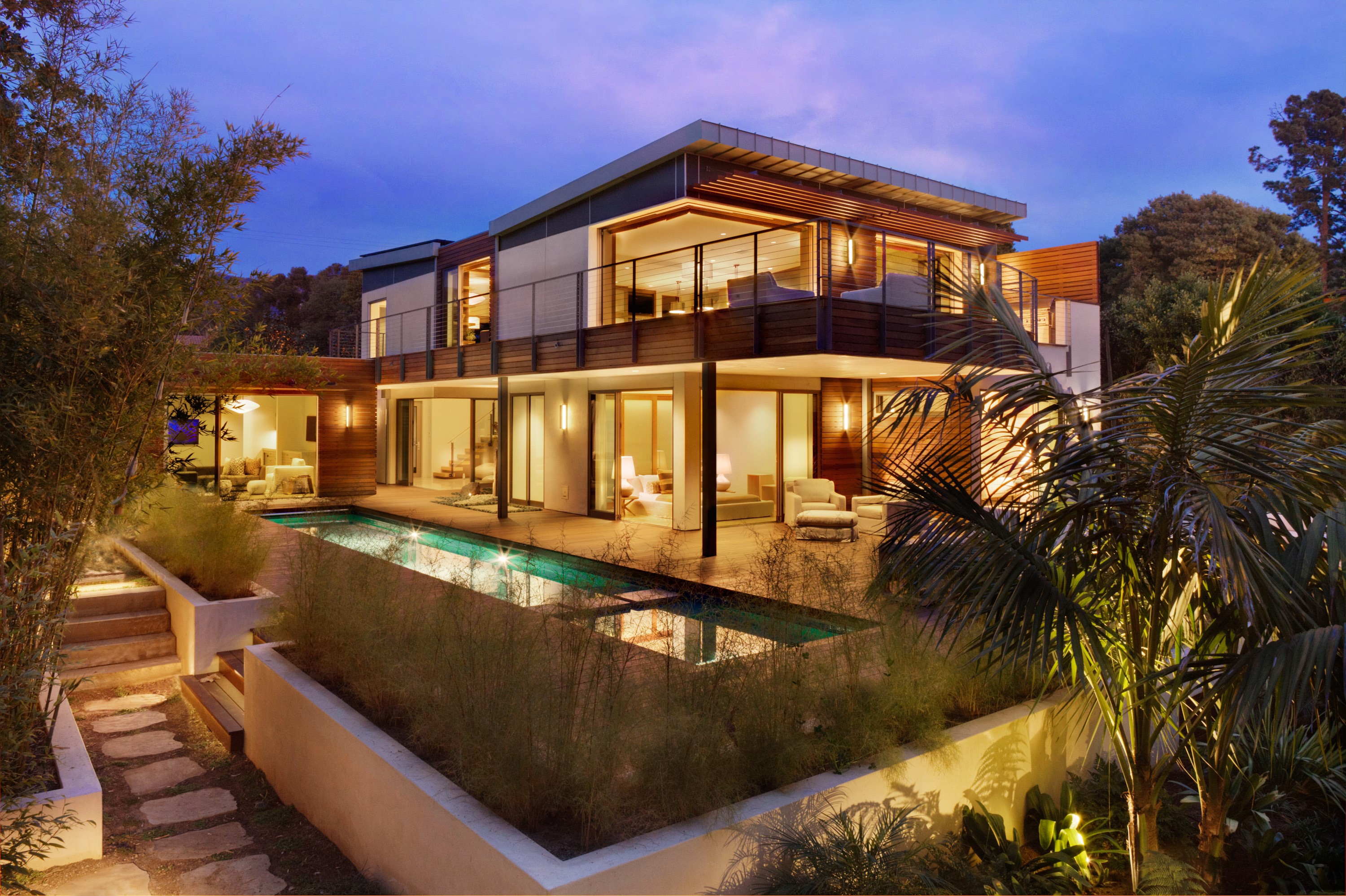 Modern multi-story house with swimming pool at dusk HD Wallpaper