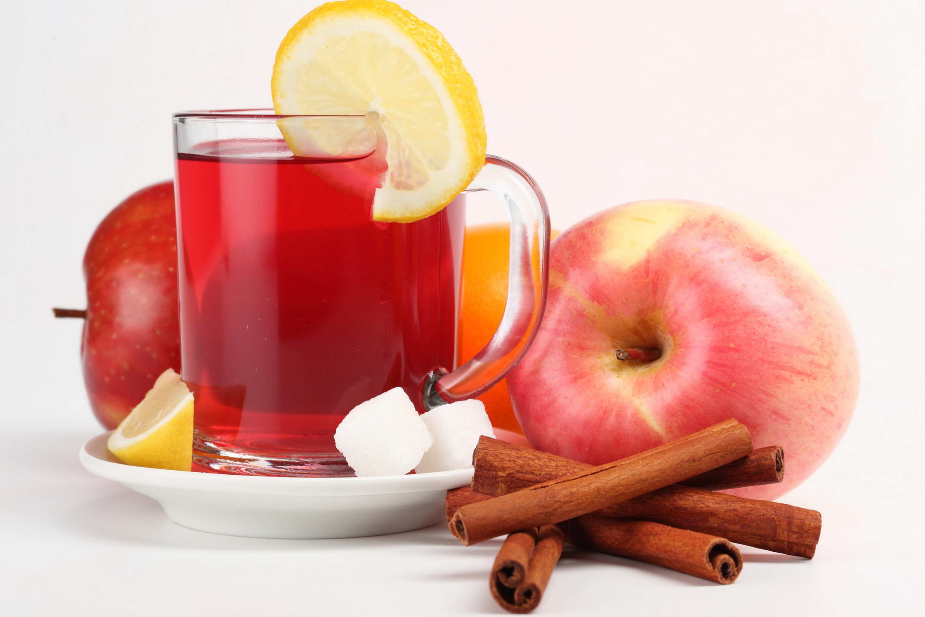 Red drink in a mug with apples, lemon, cinnamon, and sugar cubes HD Wallpaper