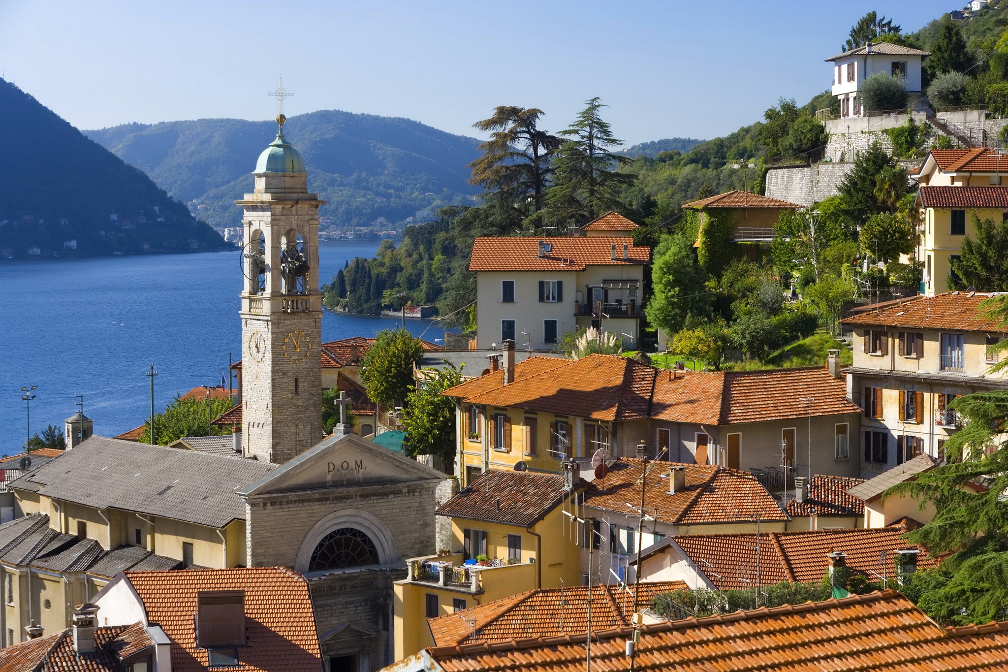 Church tower and houses overlooking a lake in Menaggio, Lombardy, Italy HD Wallpaper