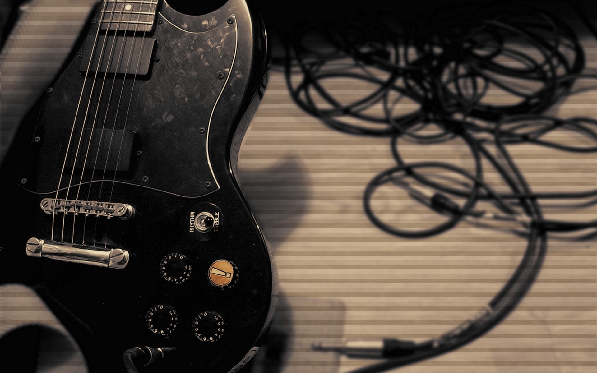 Black electric guitar with cables HD Wallpaper