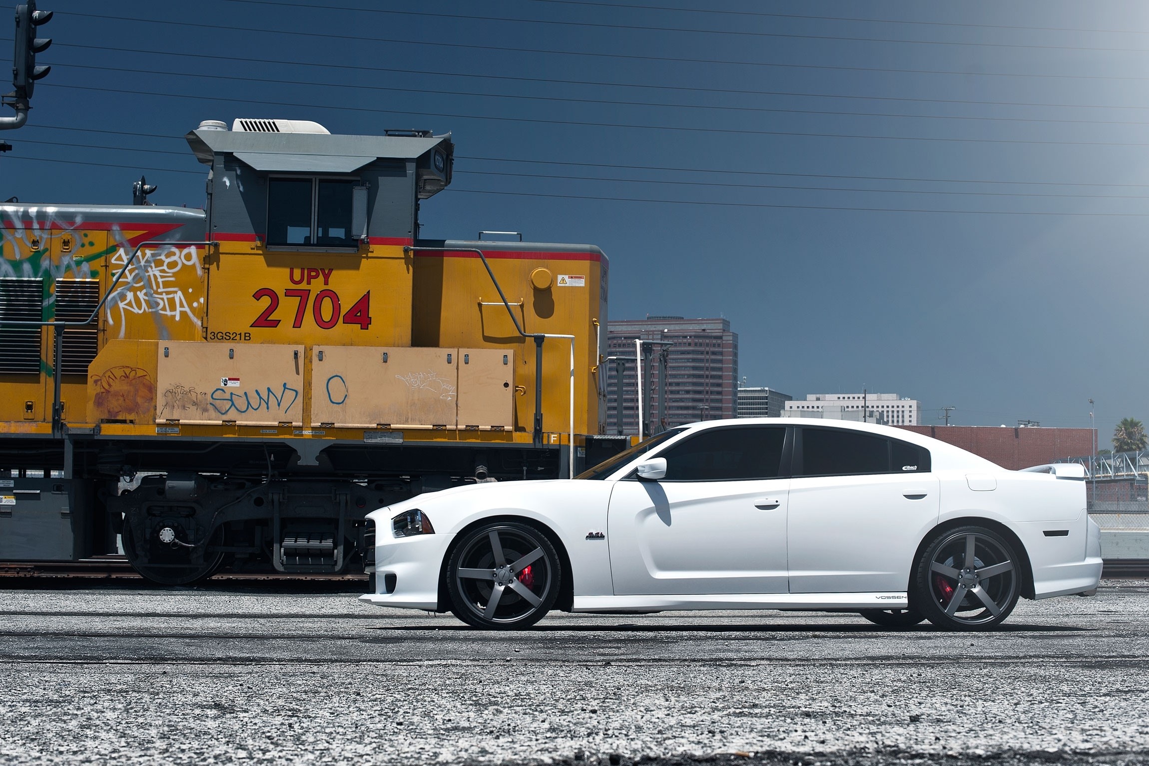 White Dodge Charger SRT8 parked next to a train HD Wallpaper