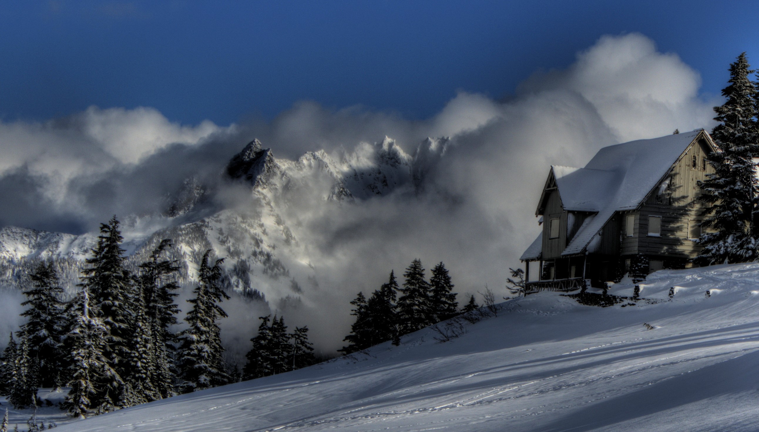 Snowy cabin in the mountains with clouds HD Wallpaper