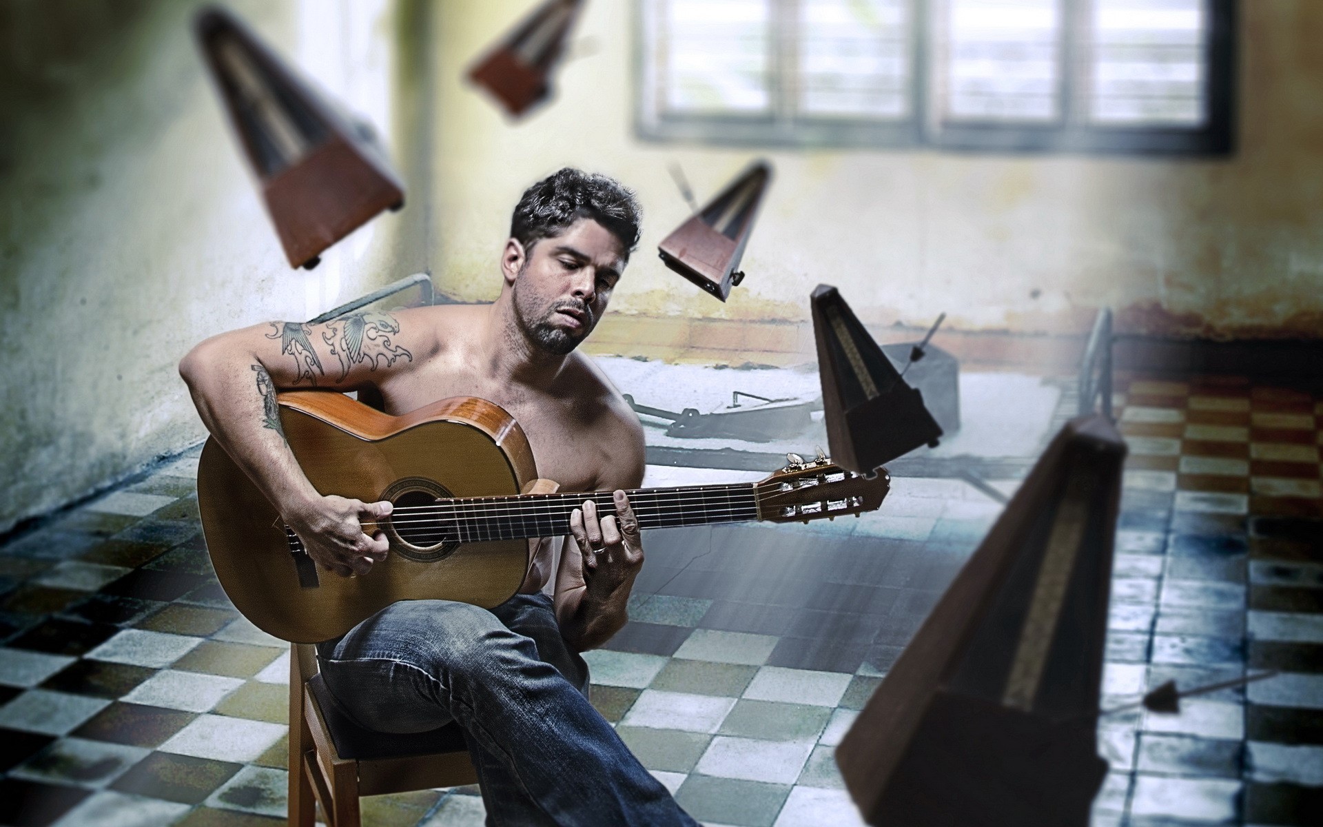 Man playing guitar surrounded by metronomes HD Wallpaper
