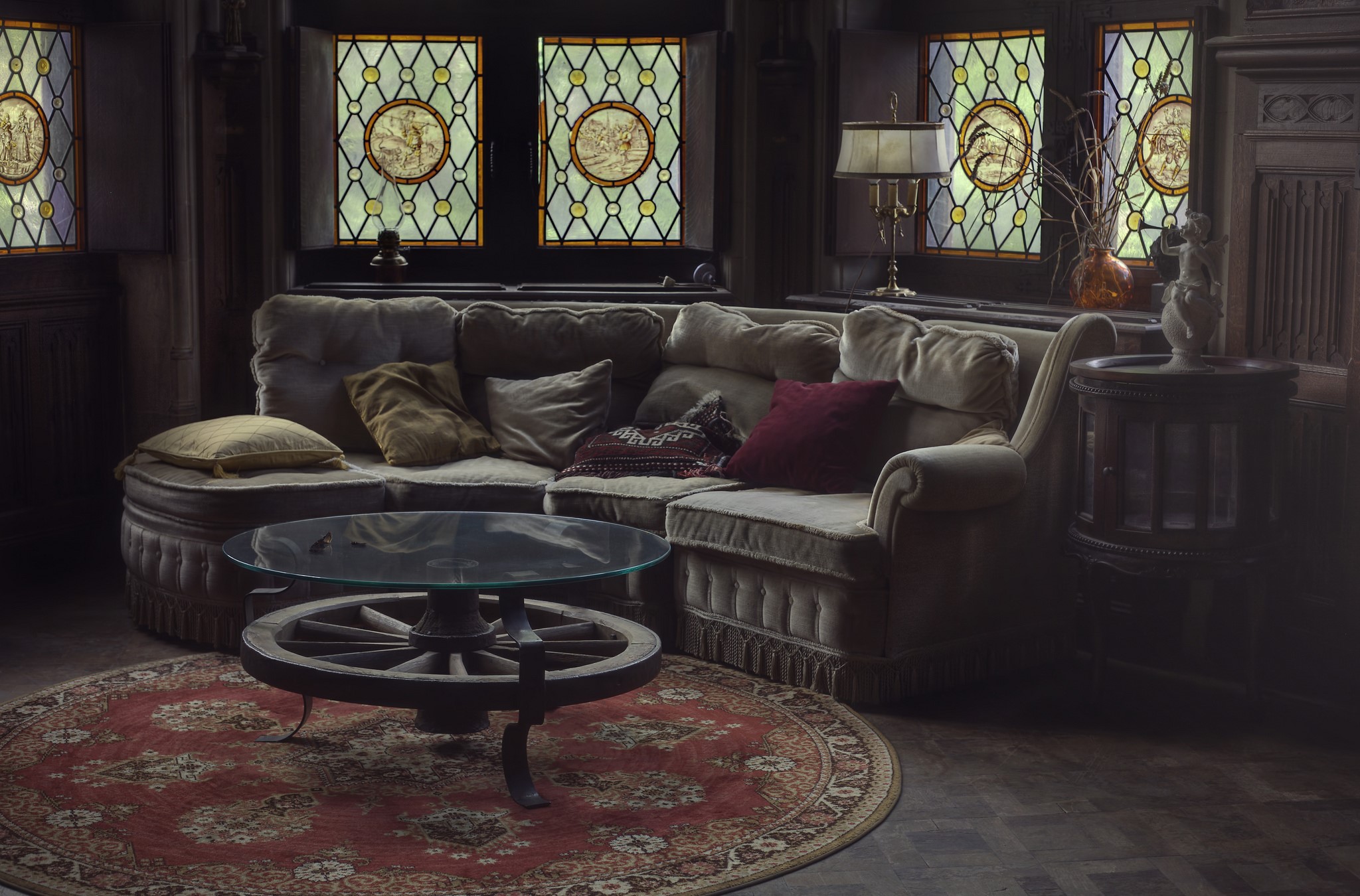 Living room with sofa, coffee table, and stained glass windows HD Wallpaper