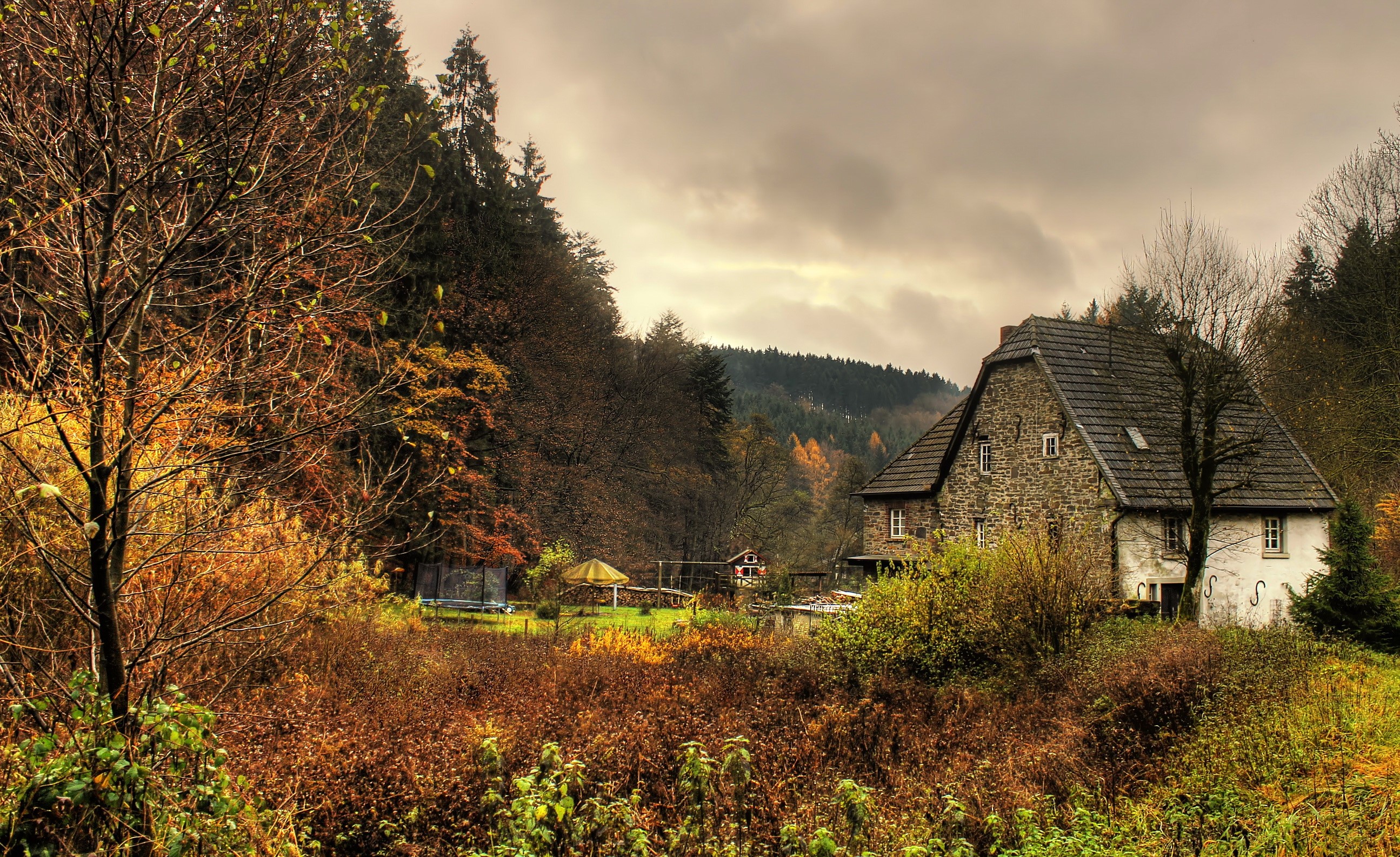 Stone house in a forest during autumn in Marienheide, Germany HD Wallpaper
