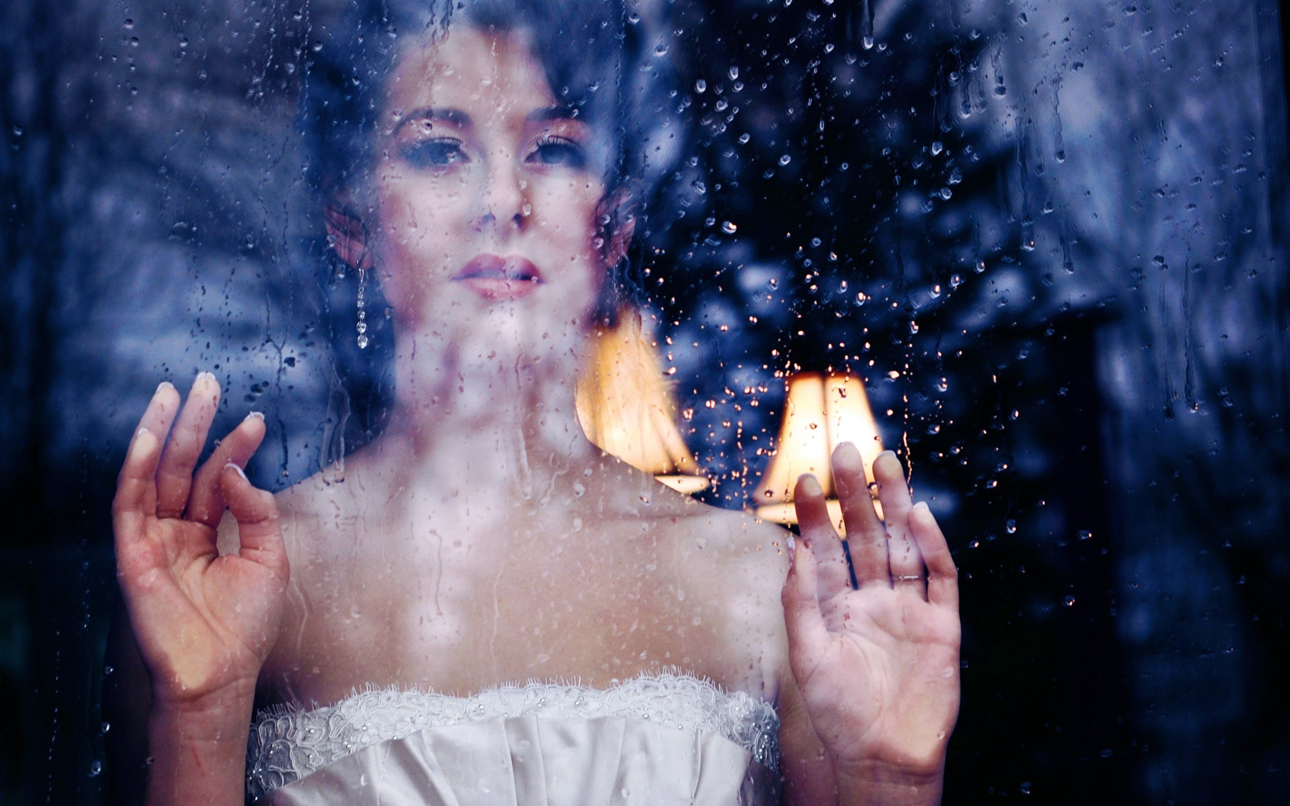 Woman in wedding dress looking through a rainy window HD Wallpaper