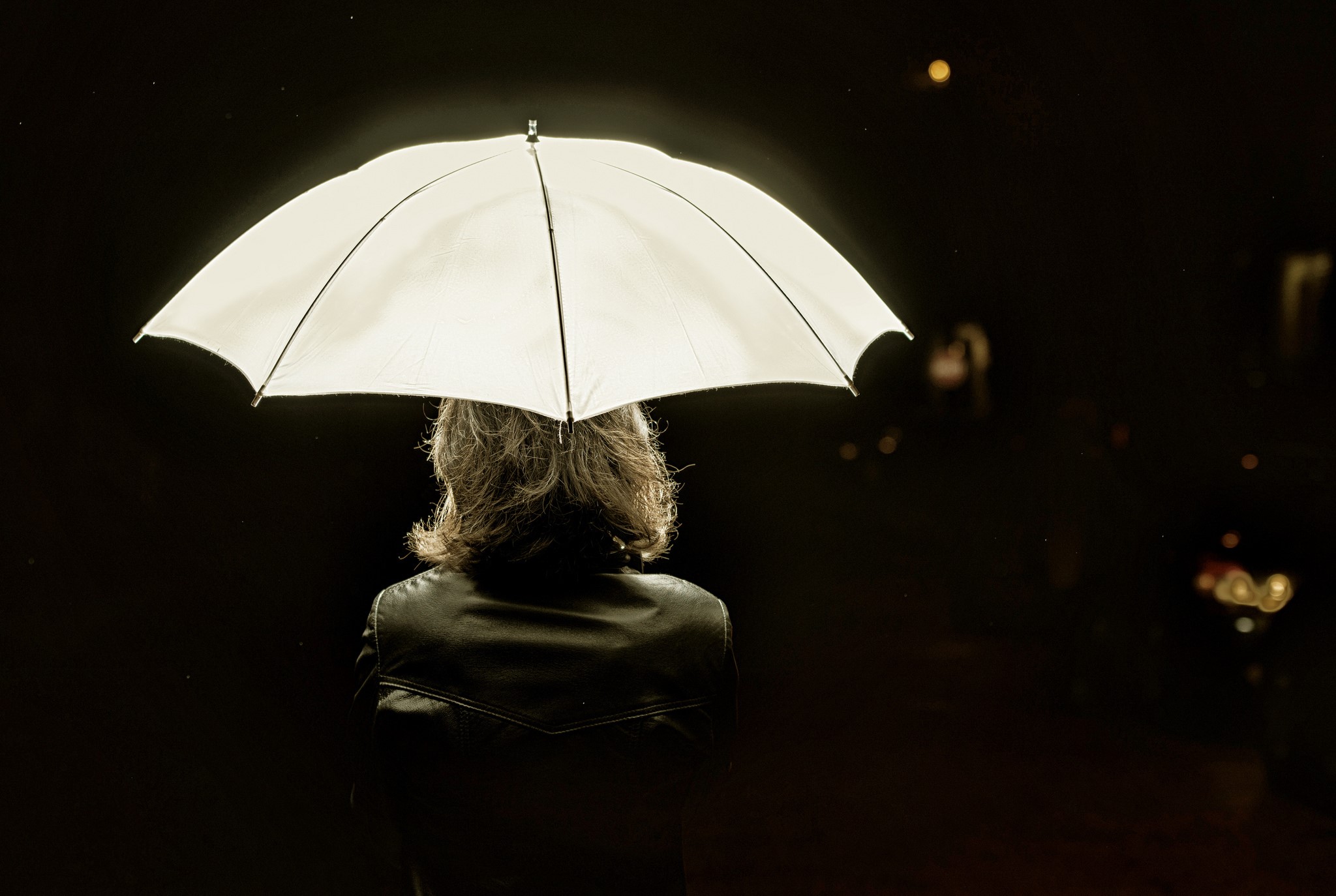 Person holding a white umbrella at night HD Wallpaper