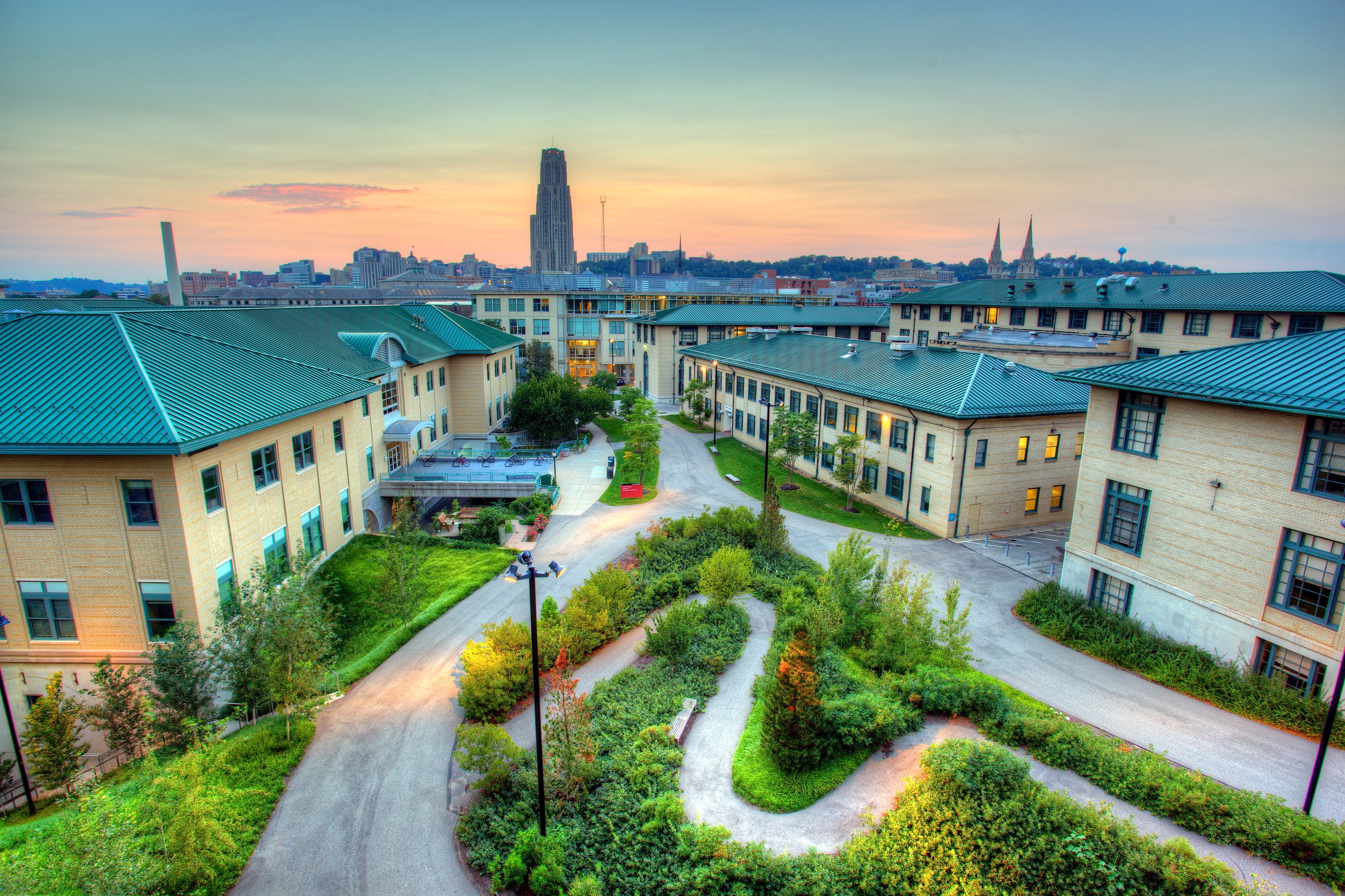 University campus with tall building in background HD Wallpaper