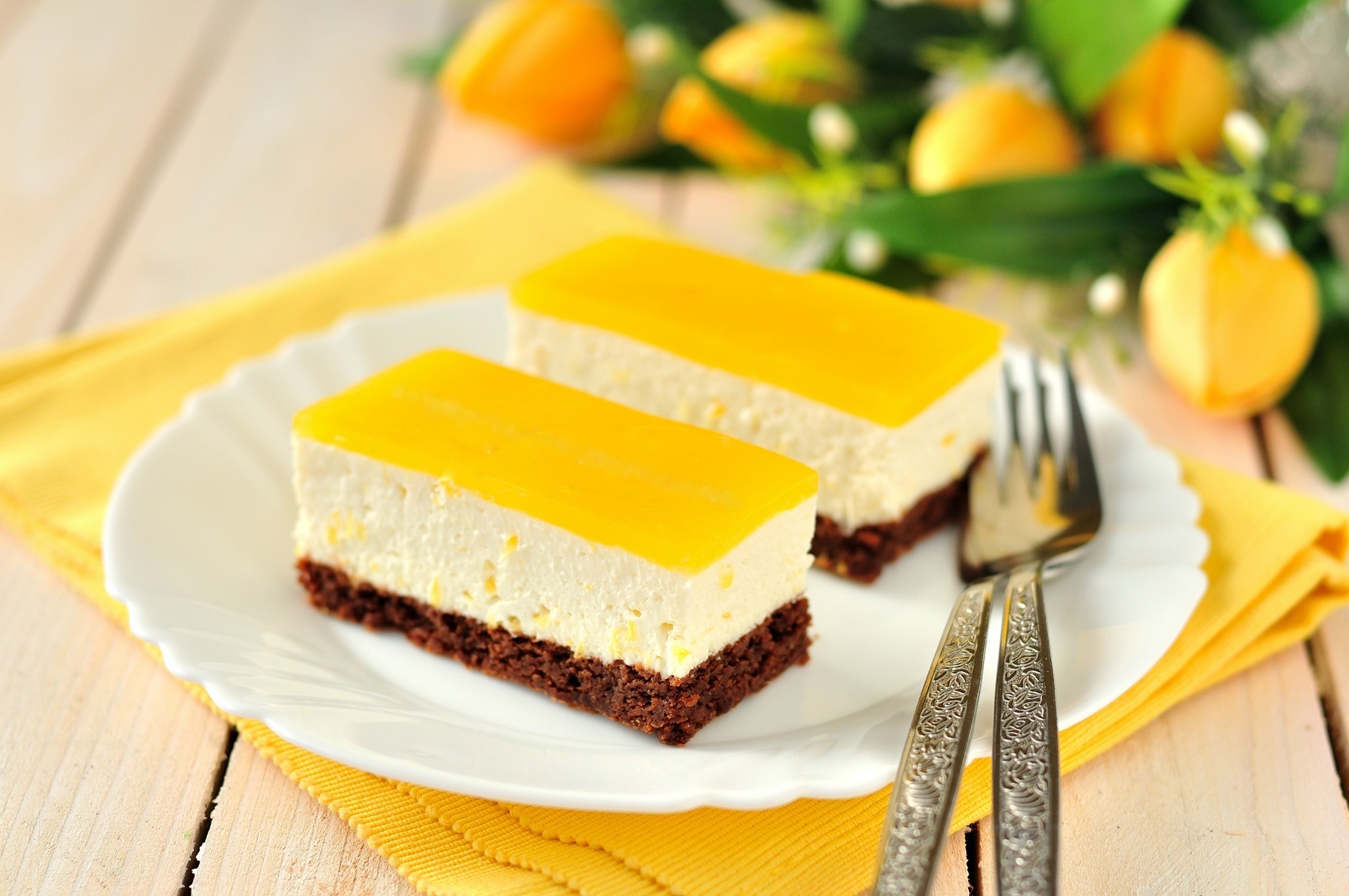 Two slices of lemon cheesecake on a plate with forks HD Wallpaper