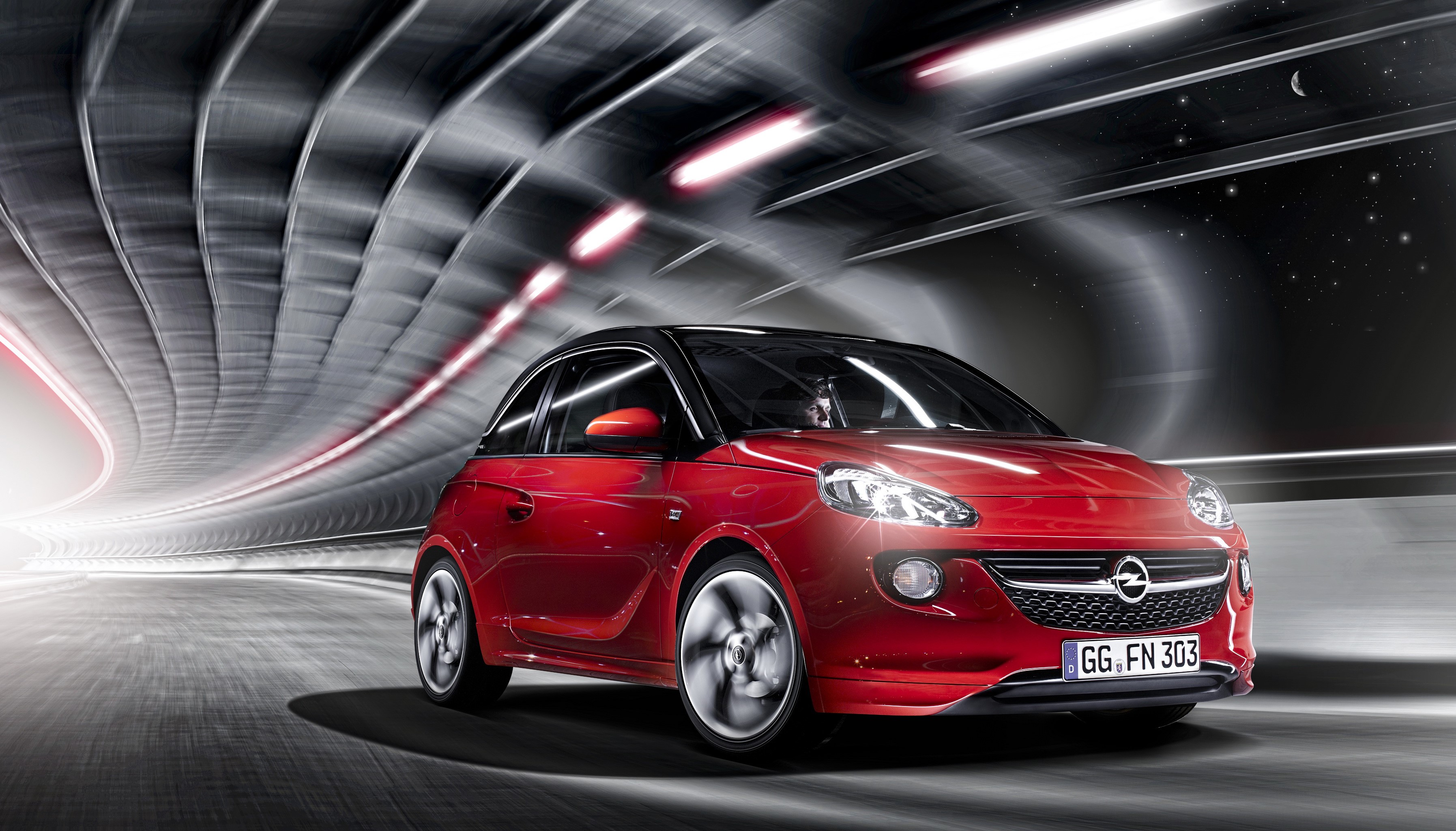 Red Opel Adam driving through a tunnel HD Wallpaper