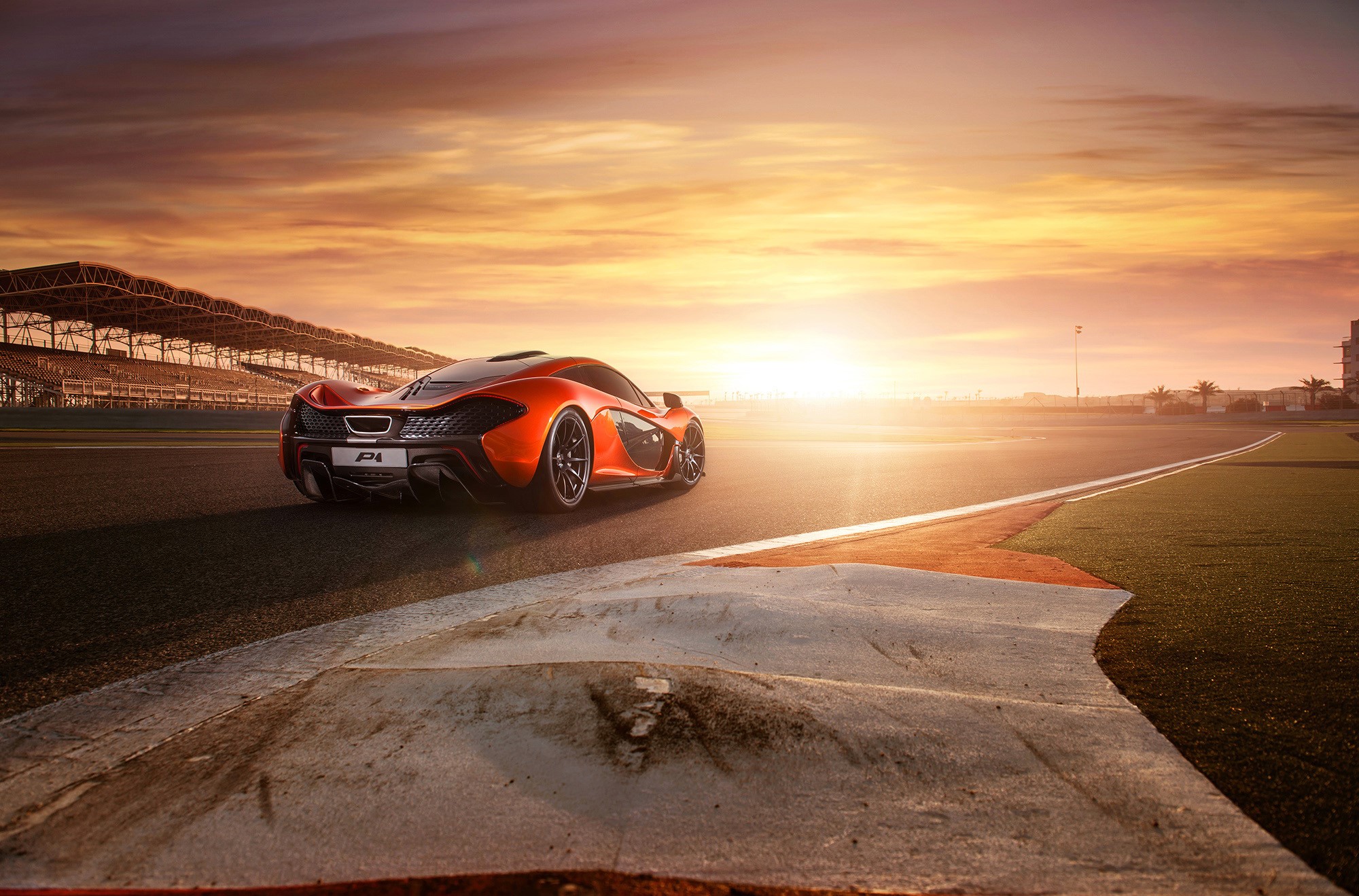 McLaren P1 on a race track at sunset HD Wallpaper