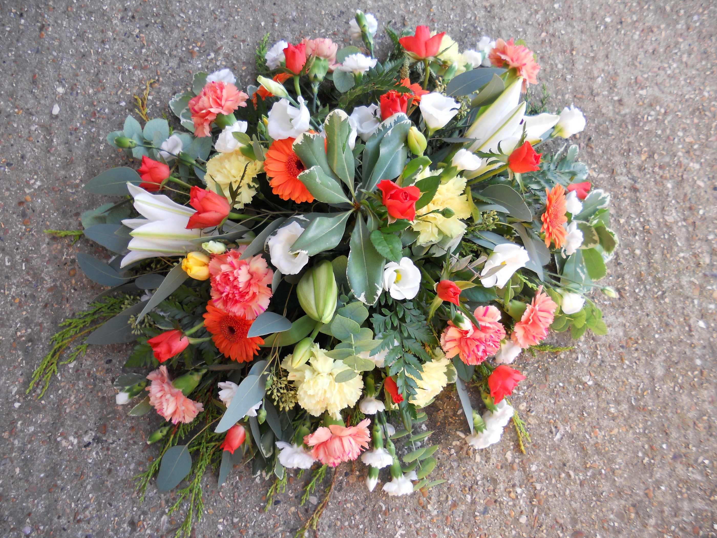 A colorful bouquet of flowers on a concrete surface HD Wallpaper