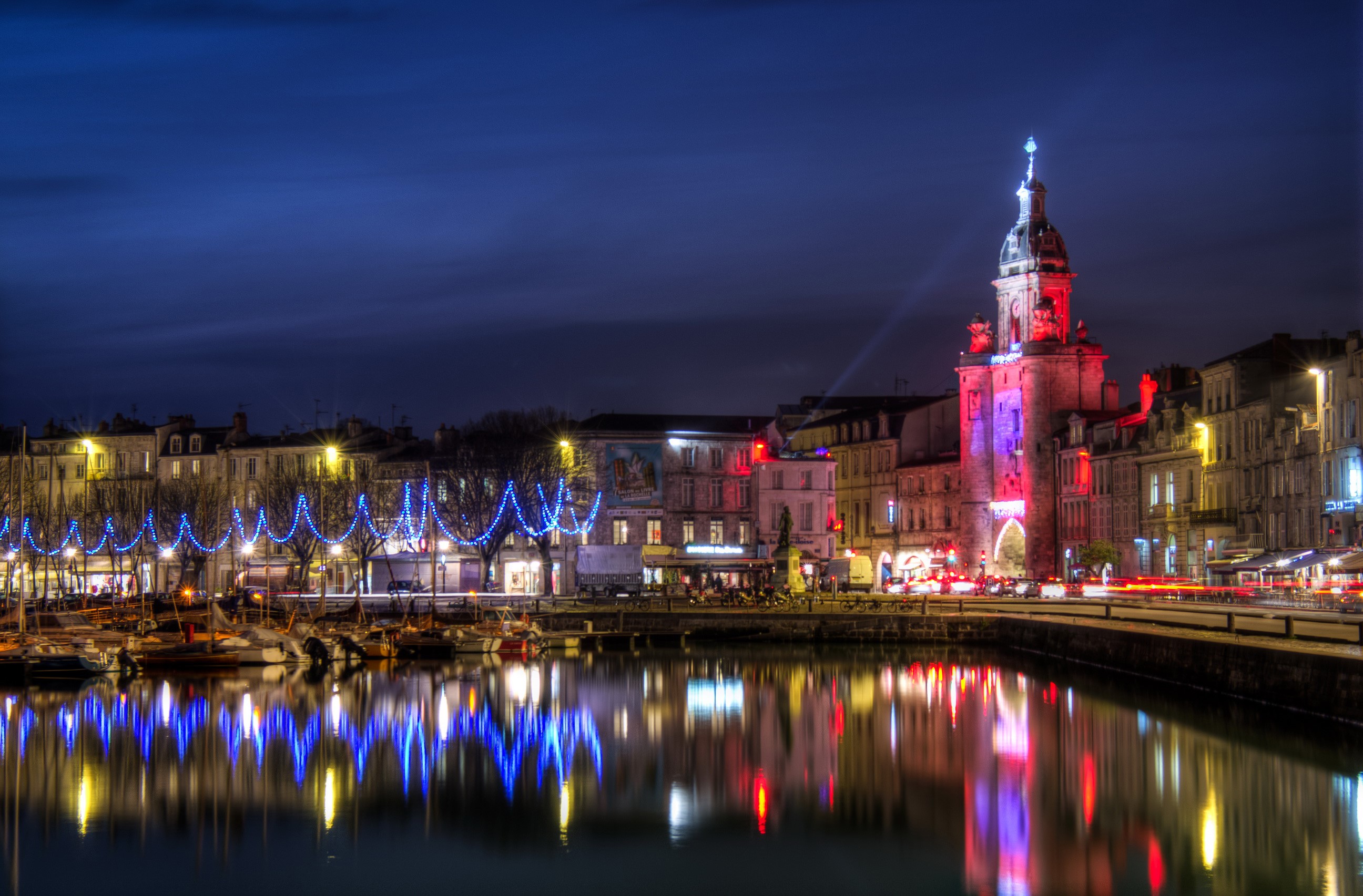 La Rochelle harbor at night with illuminated tower HD Wallpaper