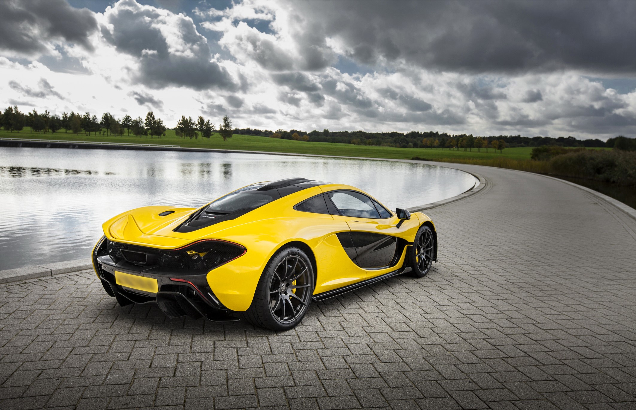 Yellow McLaren P1 car parked by a pond HD Wallpaper