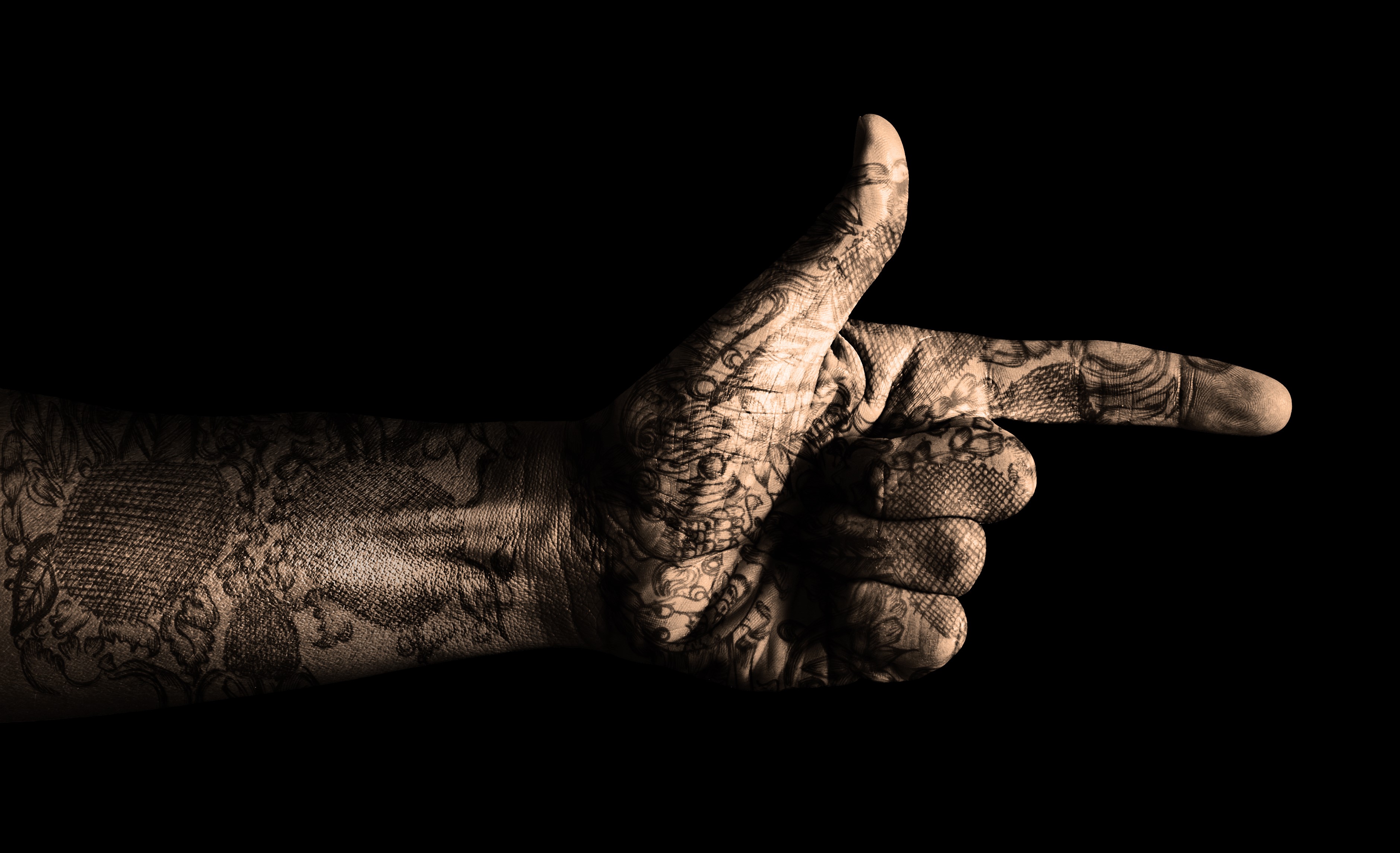 Tattooed hand pointing with index finger HD Wallpaper