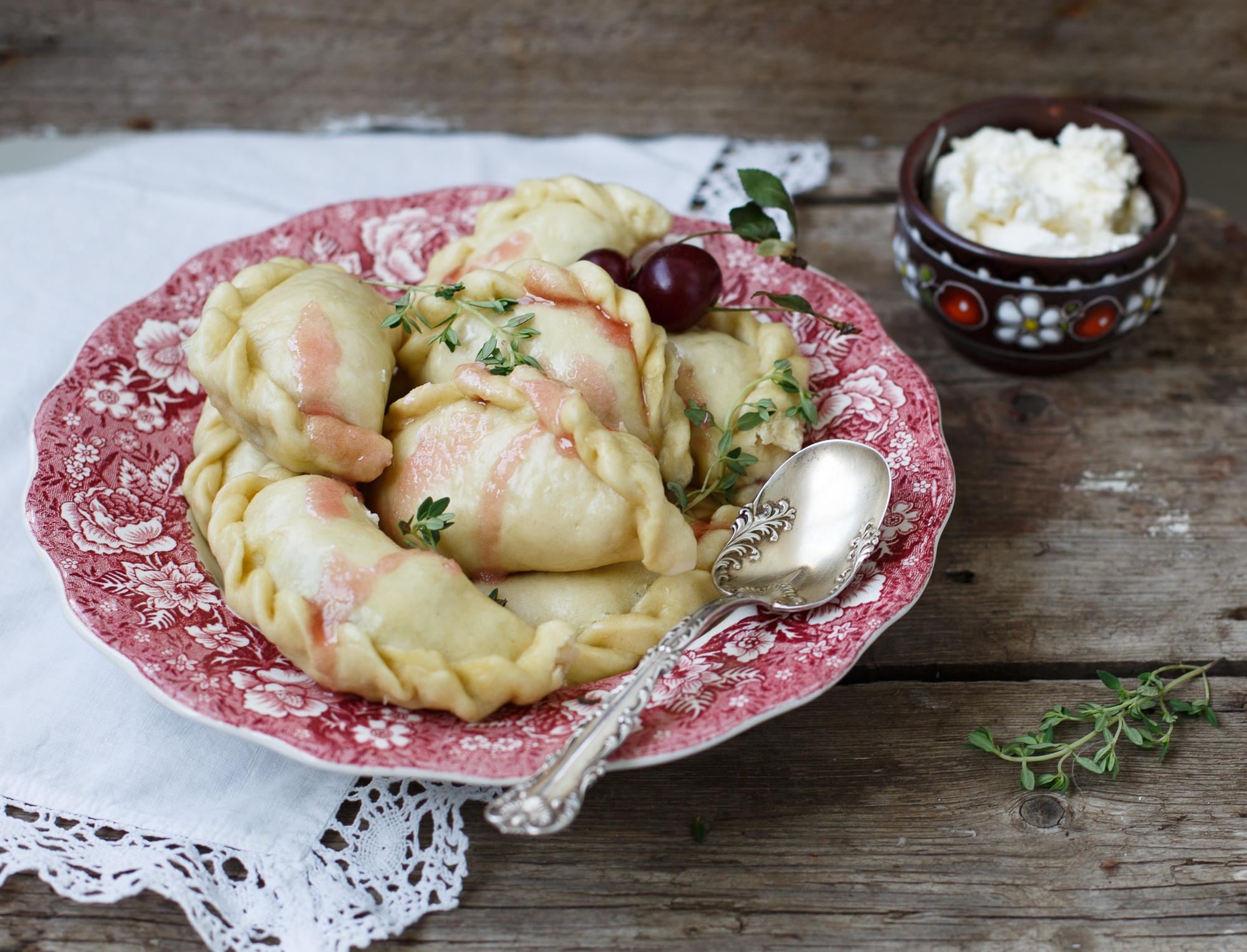 Dumplings with cherries and cottage cheese on a plate HD Wallpaper