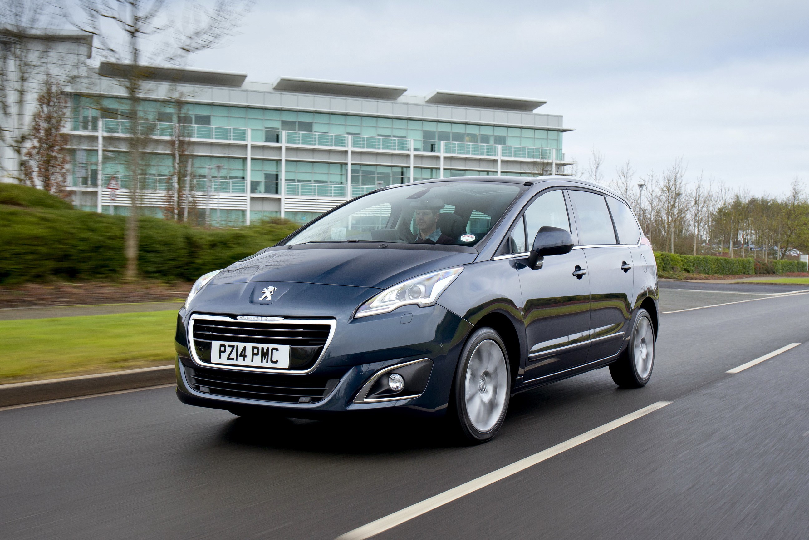 Peugeot 5008 driving on a road HD Wallpaper
