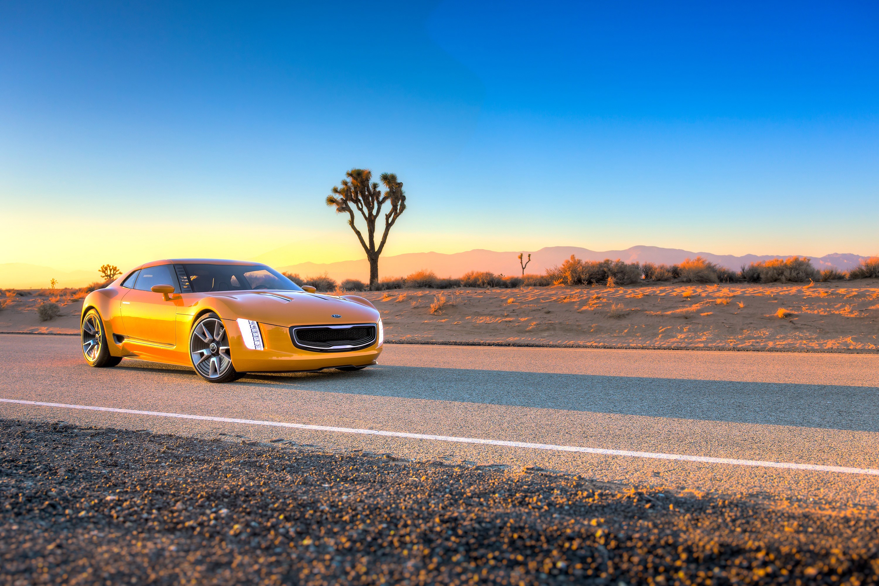 Yellow Kia Stinger GT4 concept car on desert road HD Wallpaper