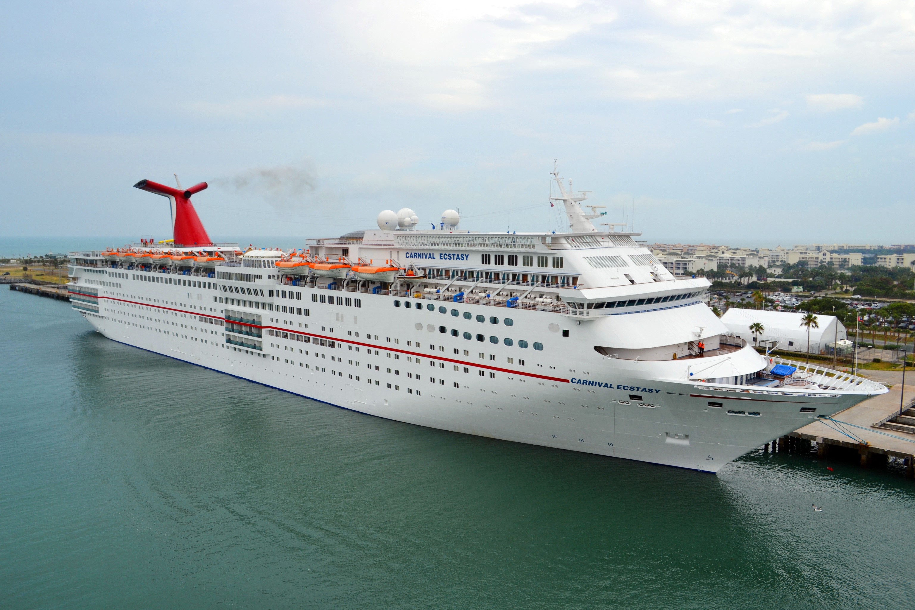 Carnival Ecstasy cruise ship docked at a marina HD Wallpaper