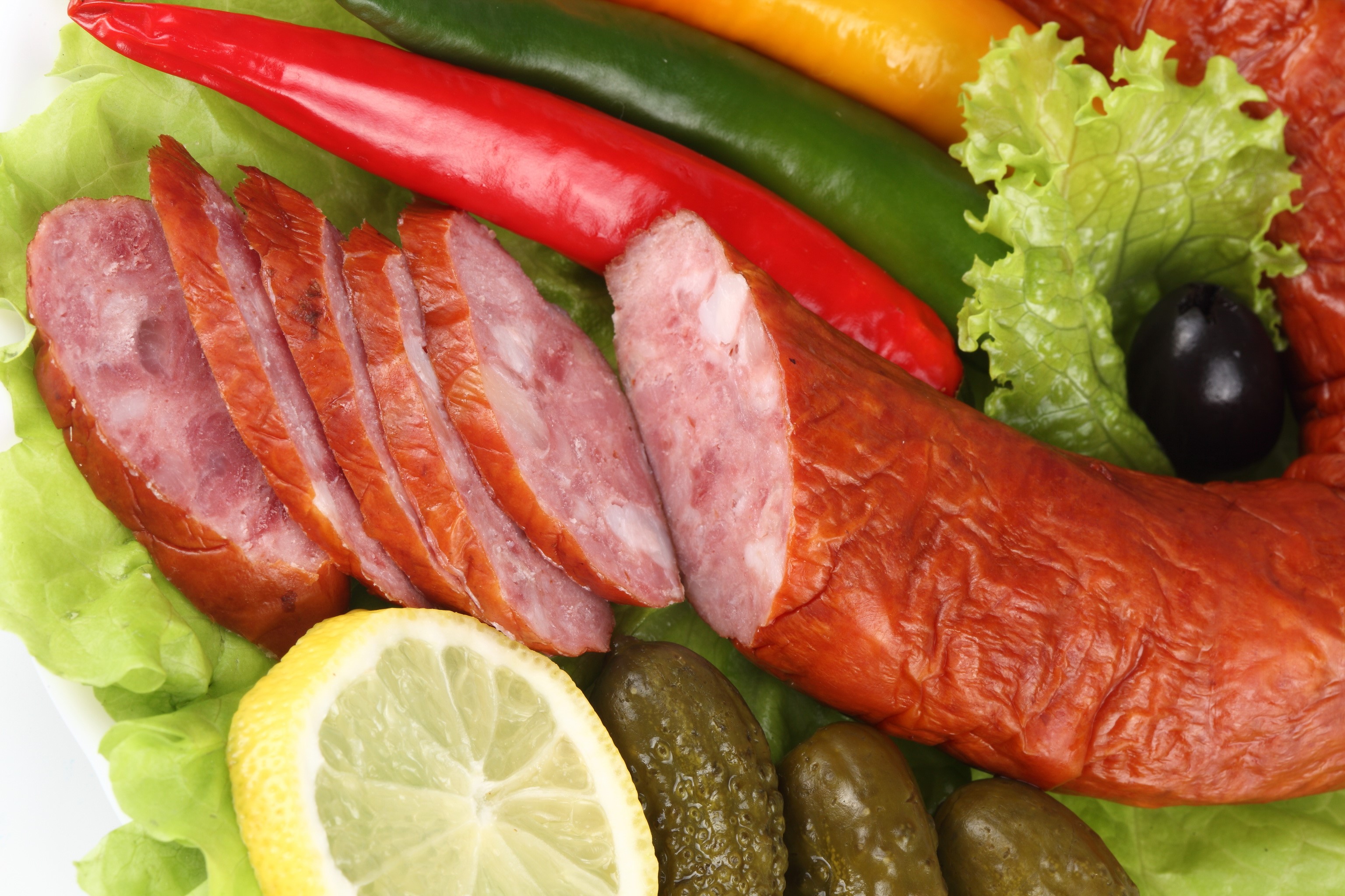 Sliced sausage with chili peppers, lemon, and pickles HD Wallpaper
