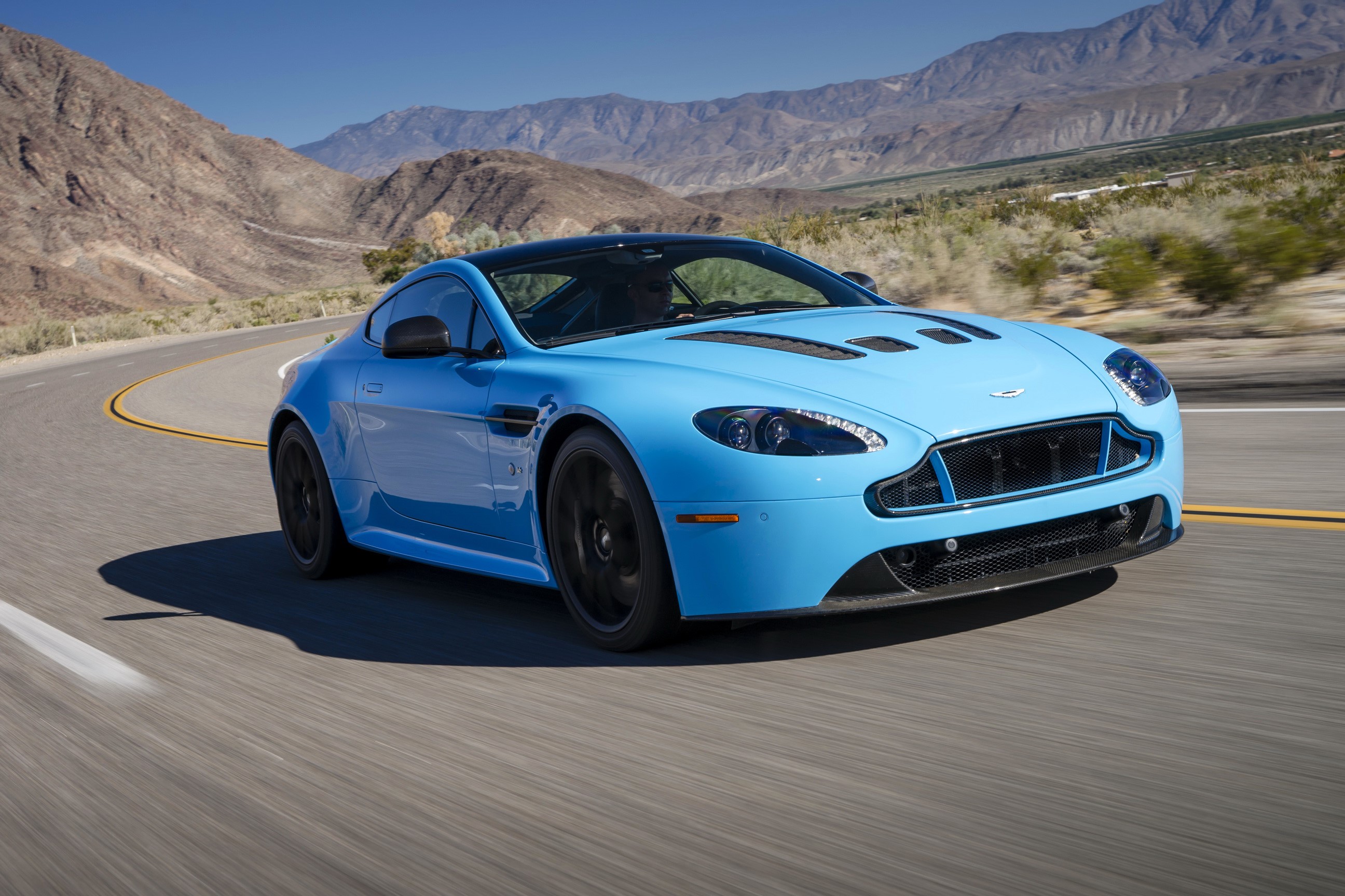 Light Blue Aston Martin V12 Vantage S on a Desert Road HD Wallpaper