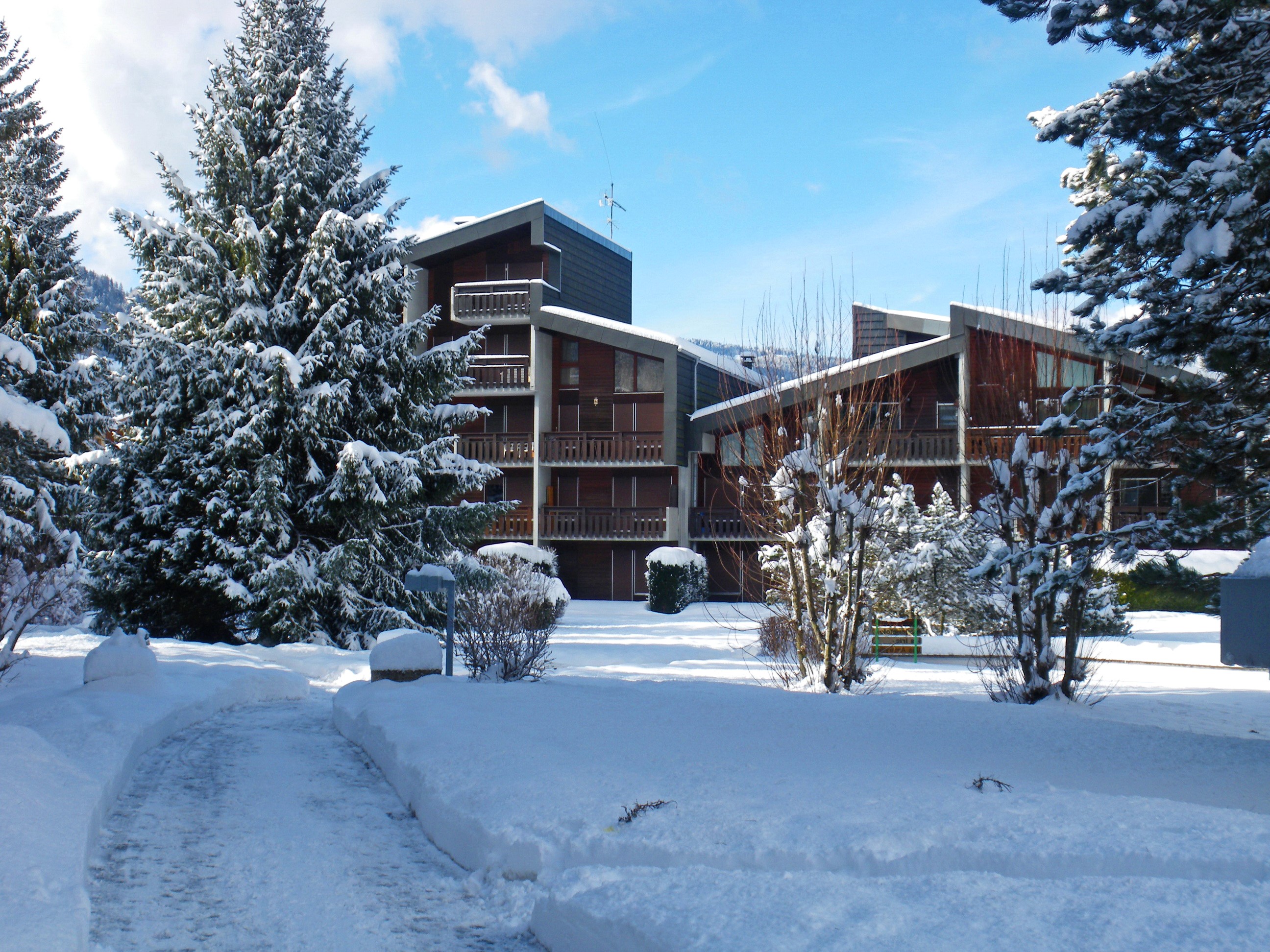 Apartment buildings in Morillon, France during winter HD Wallpaper