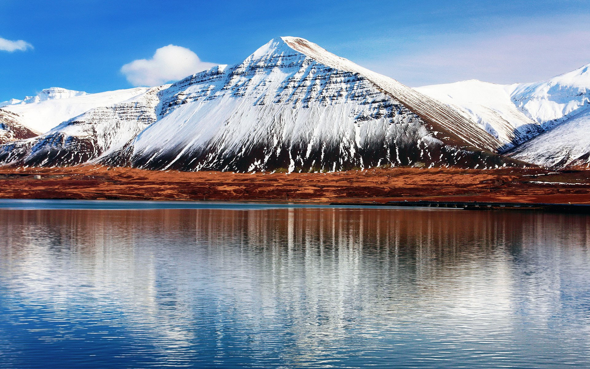 Snow-capped mountains reflected in a lake HD Wallpaper
