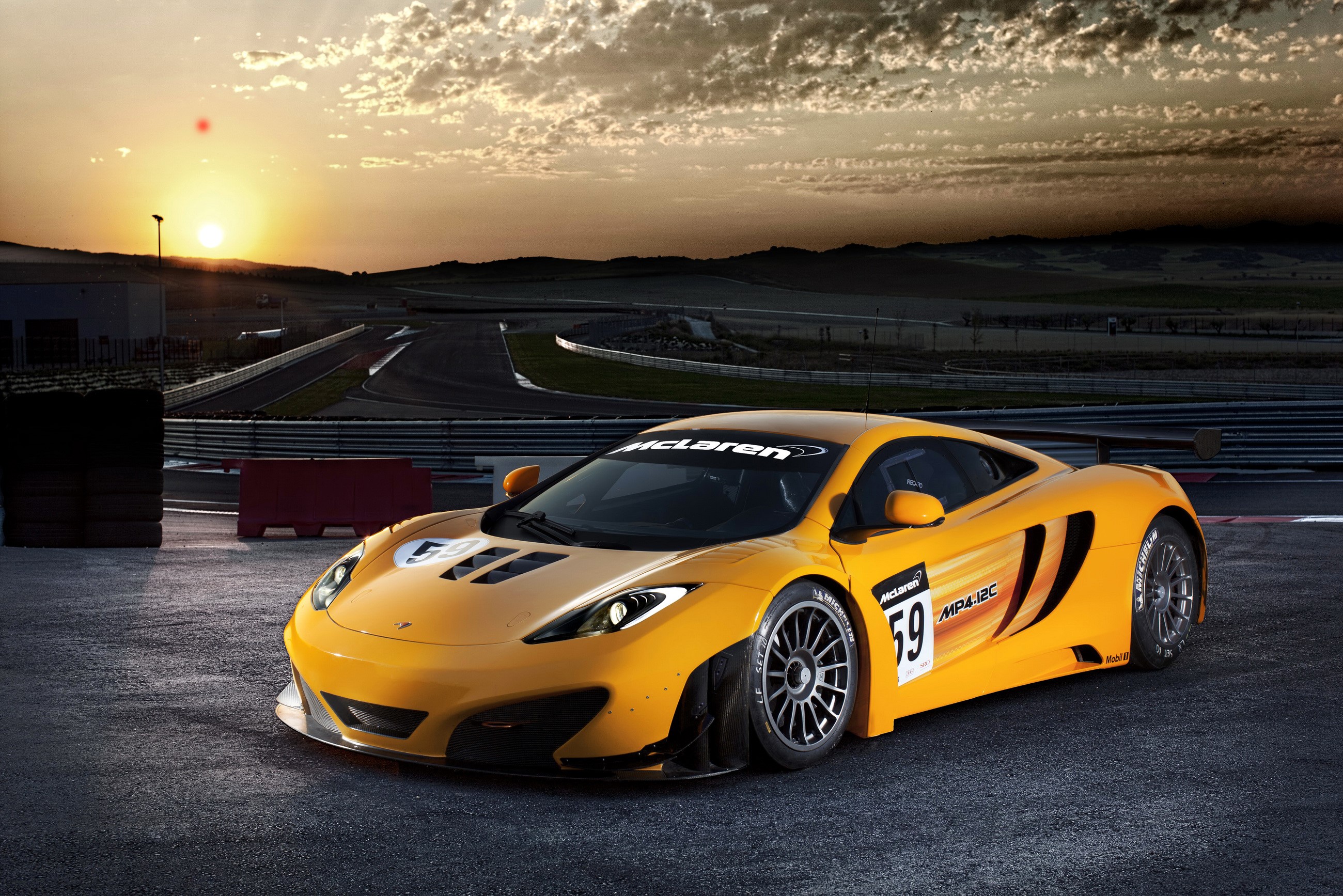 Yellow McLaren MP4-12C GT3 race car on track HD Wallpaper