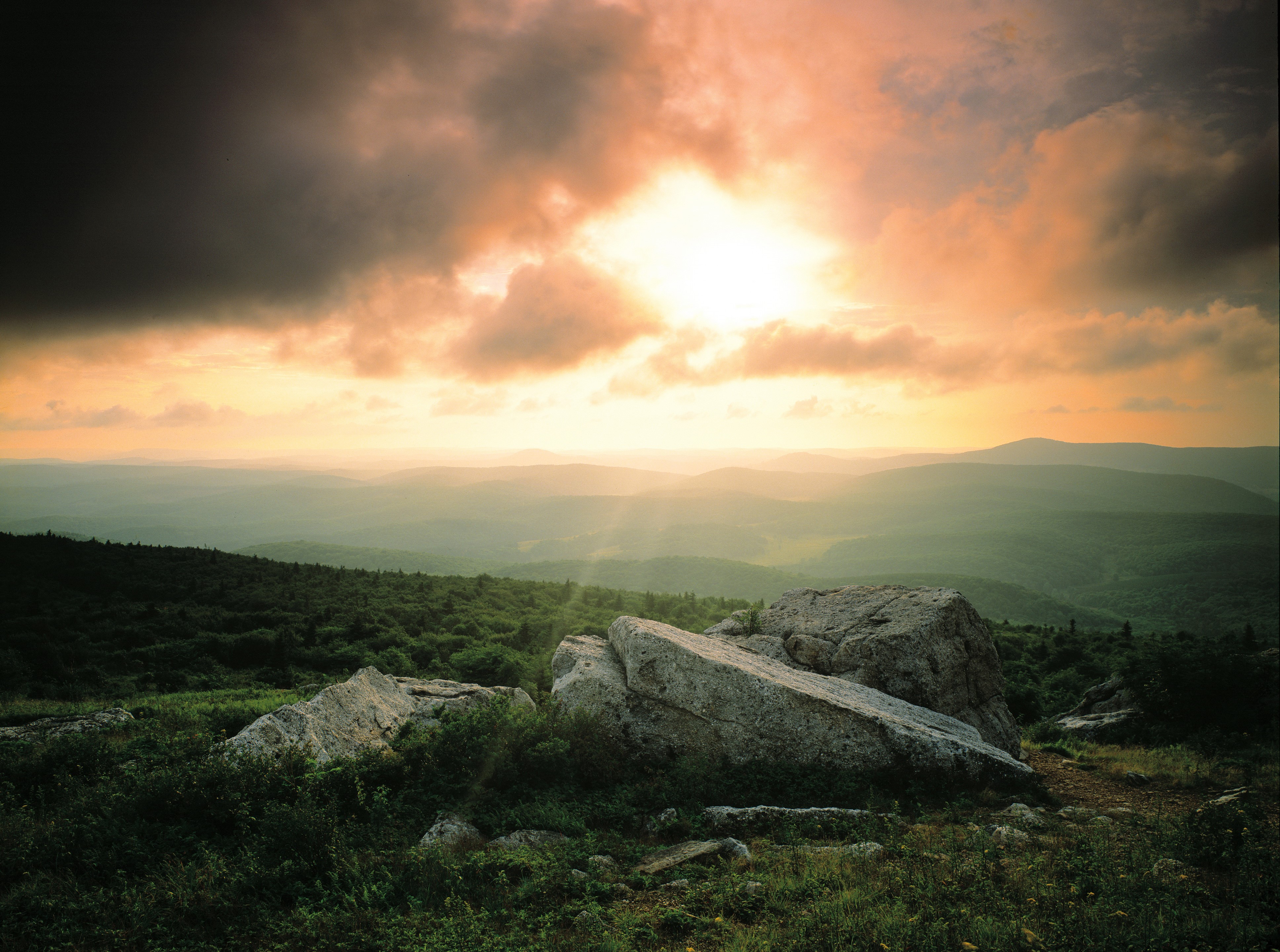 Sunset over rolling hills with rocks HD Wallpaper