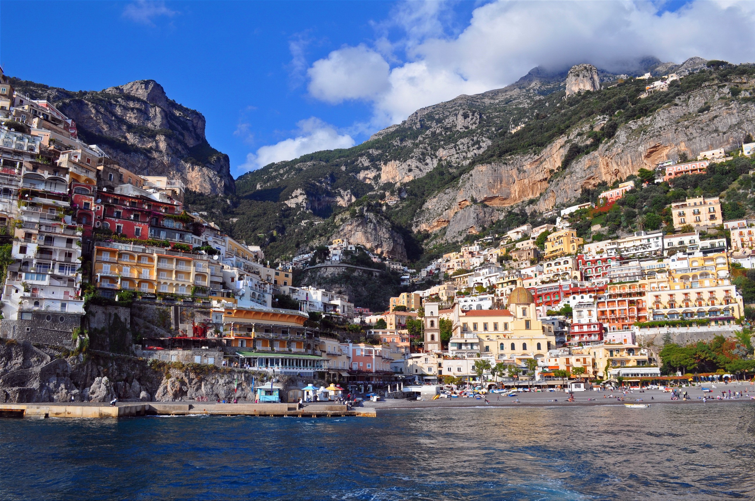 Positano, Italy coast with colorful houses on a mountainside overlooking the sea HD Wallpaper