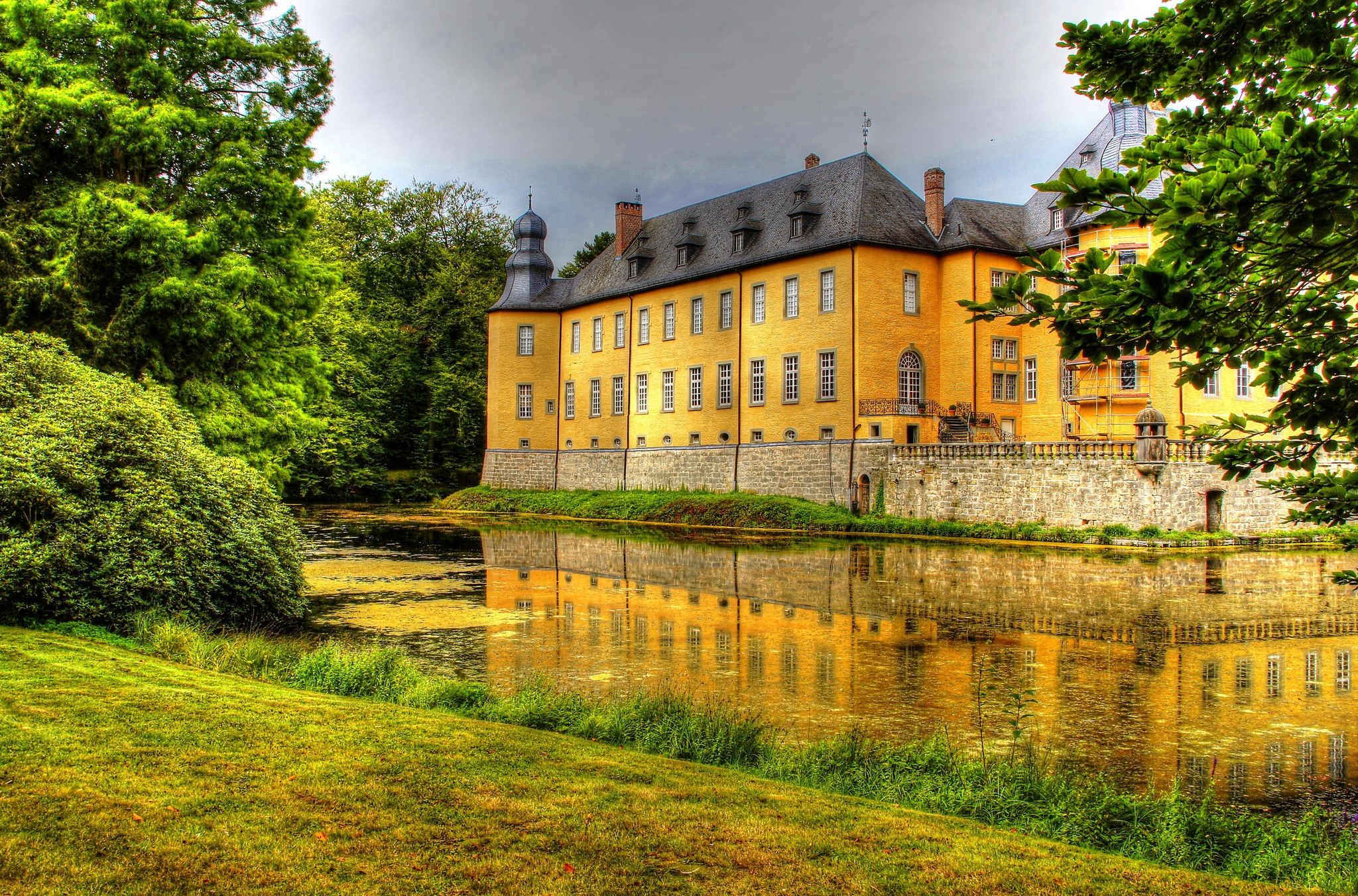 Yellow castle reflected in a pond in Dyck, Germany HD Wallpaper