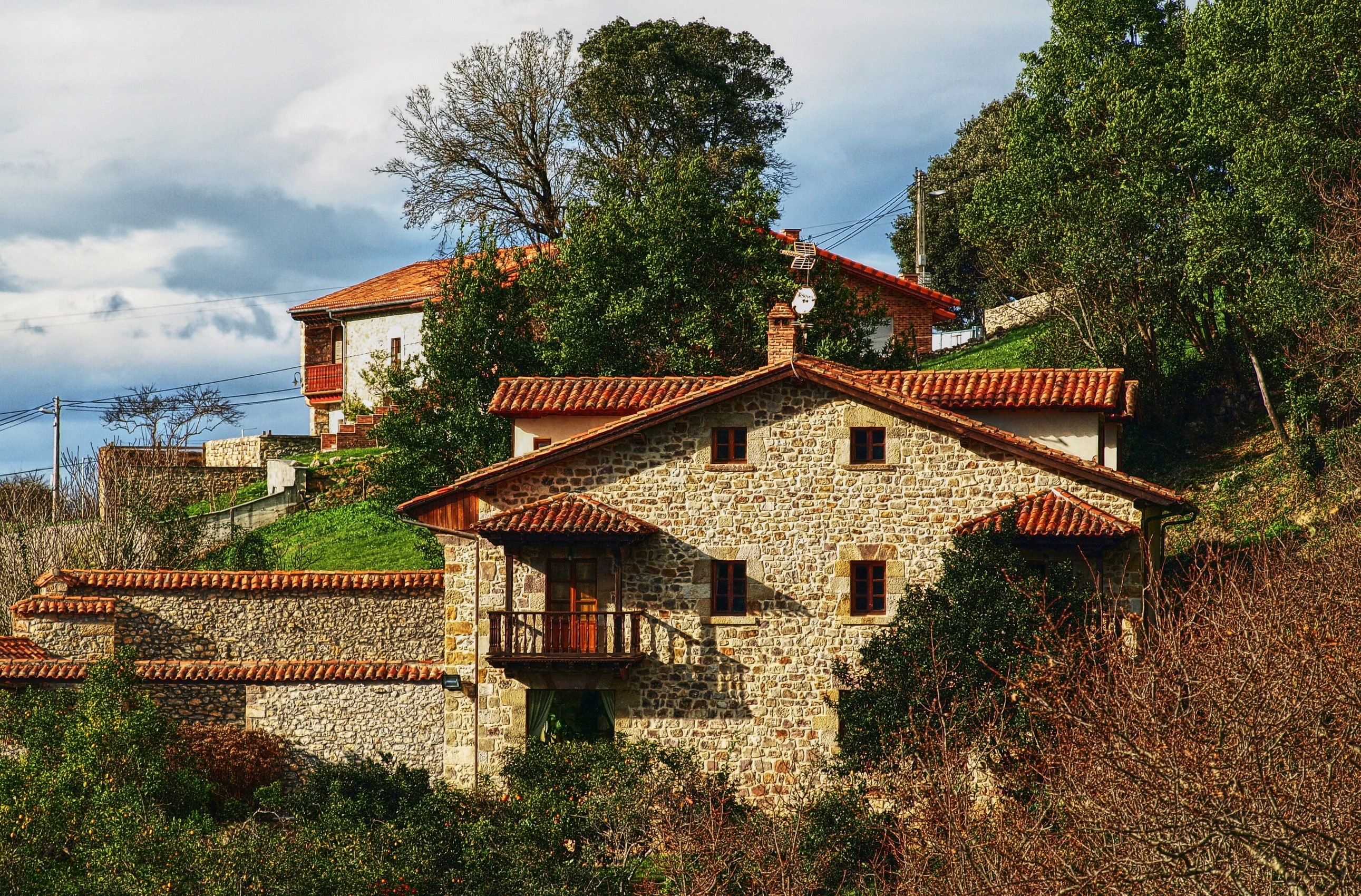 Stone houses with red tile roofs in Kantabria, Spain HD Wallpaper
