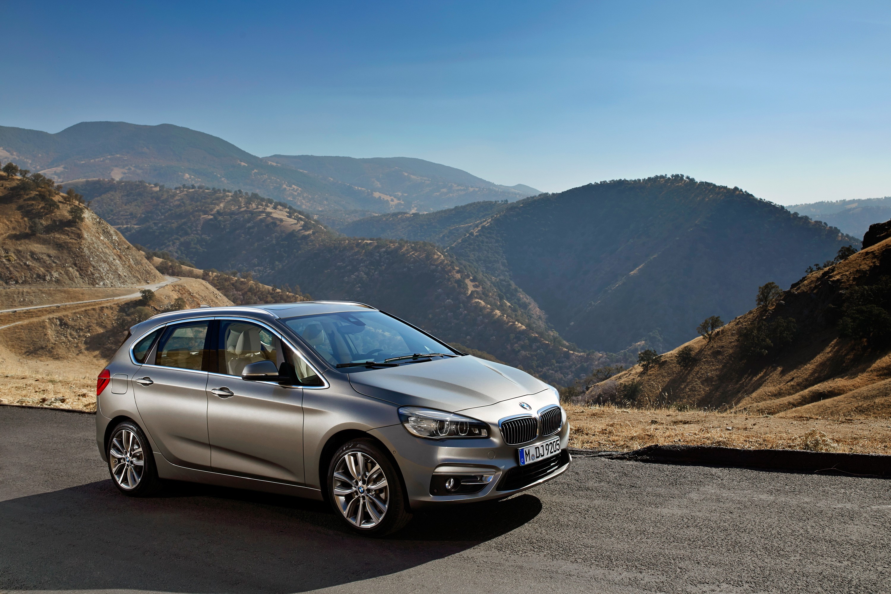 Silver BMW 224i Active Tourer on a mountain road HD Wallpaper
