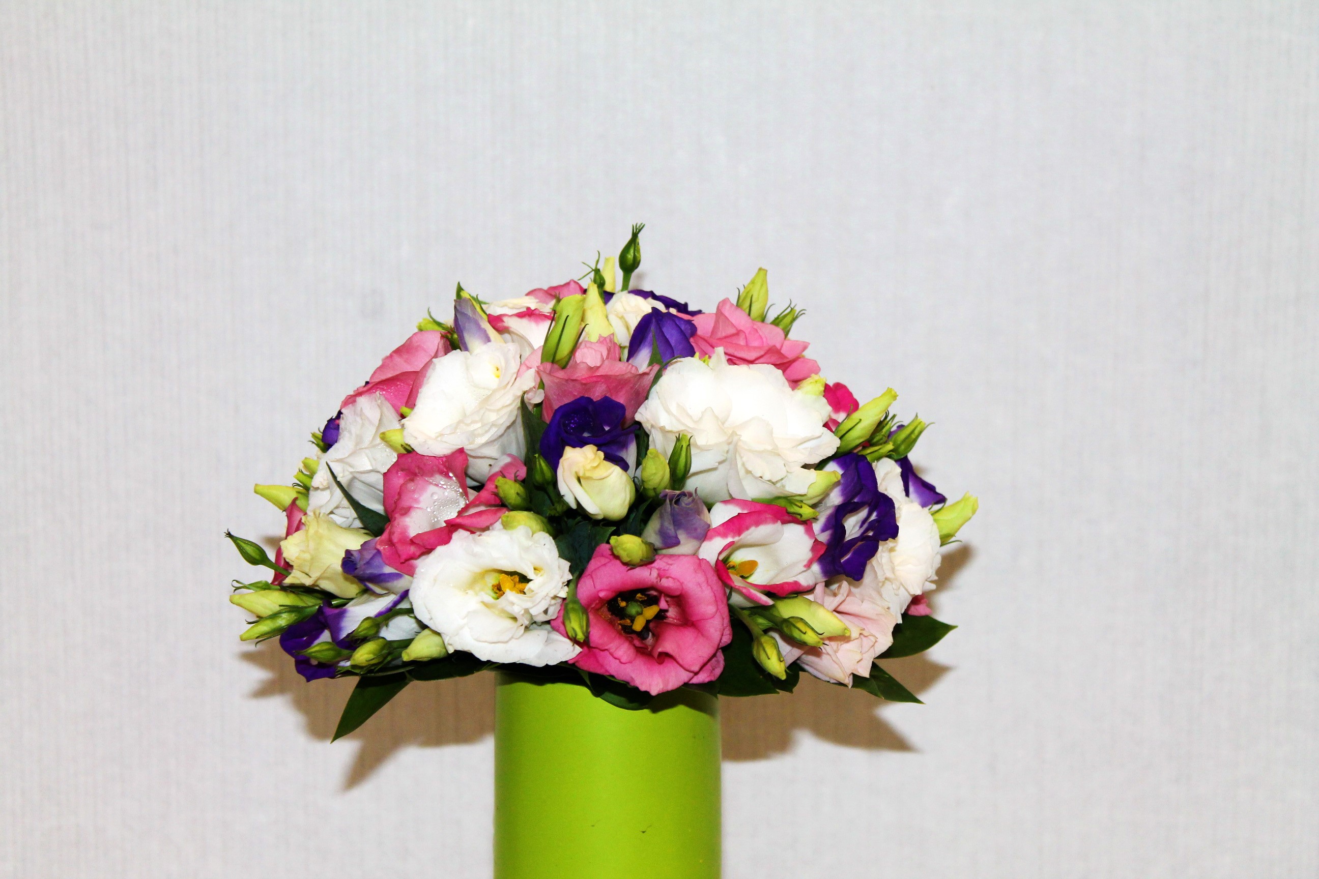 Bouquet of Eustoma flowers in a green vase HD Wallpaper