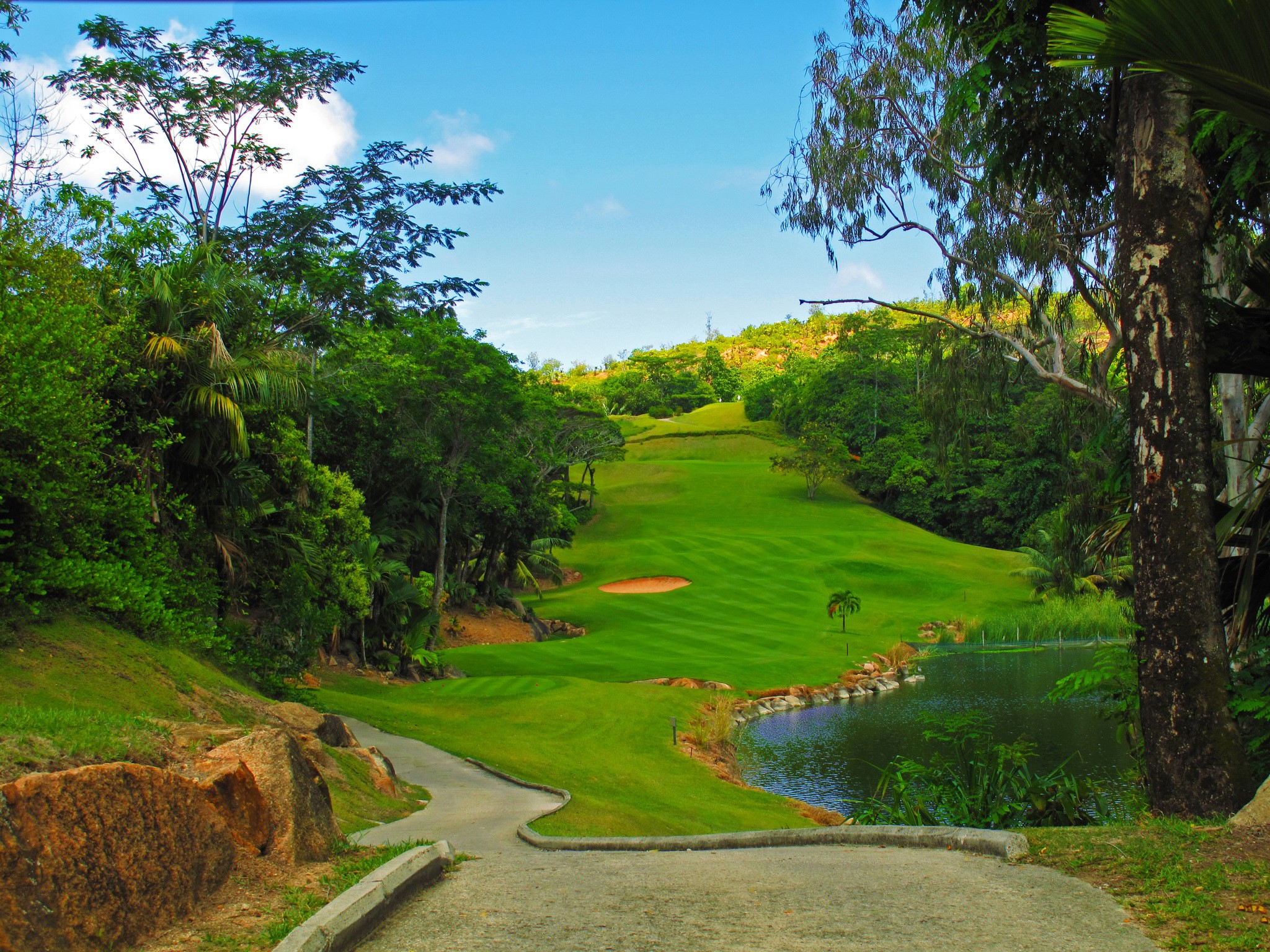 Golf course with pond and trees in Praslin, Seychelles HD Wallpaper