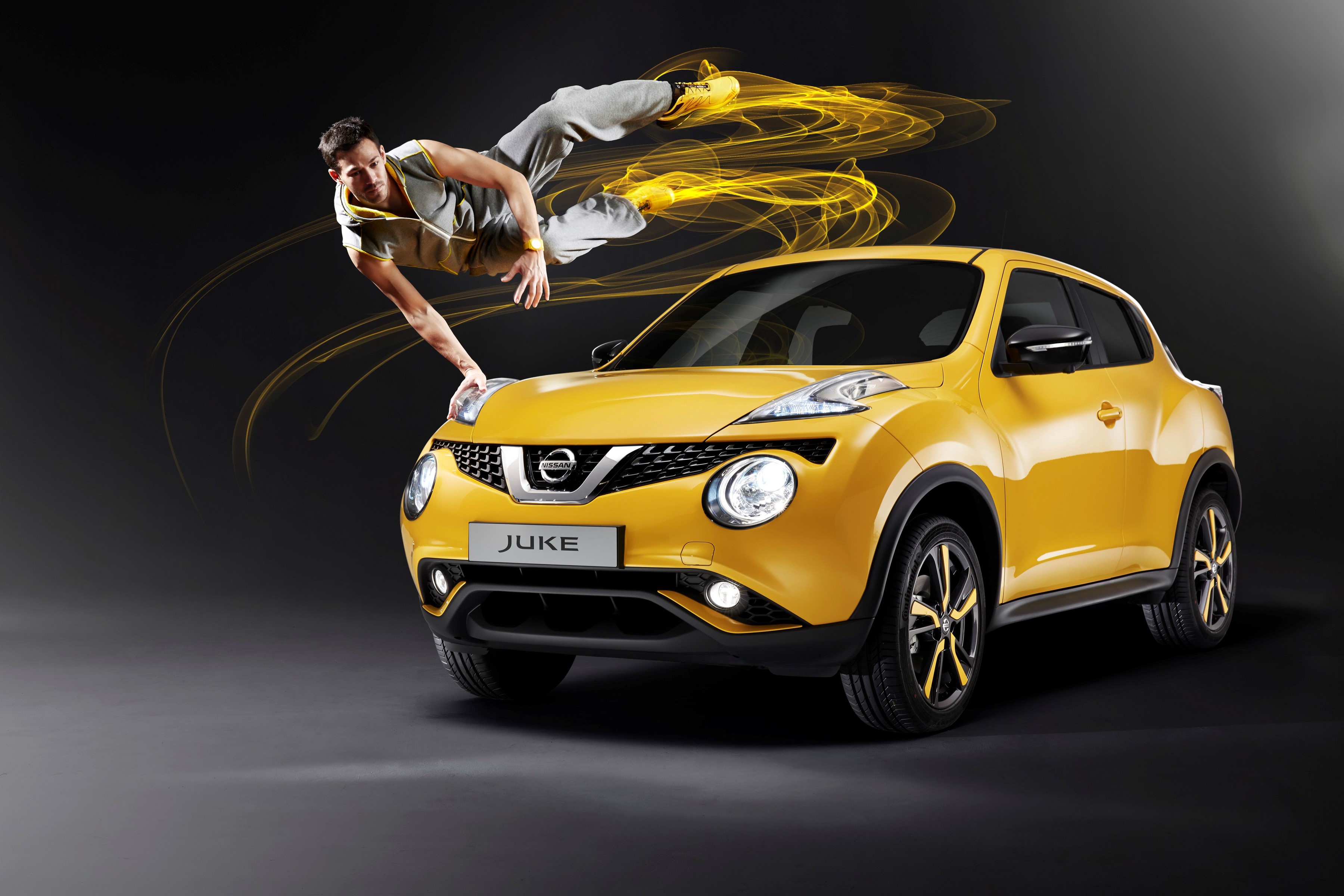 Man breakdancing on a yellow Nissan Juke HD Wallpaper