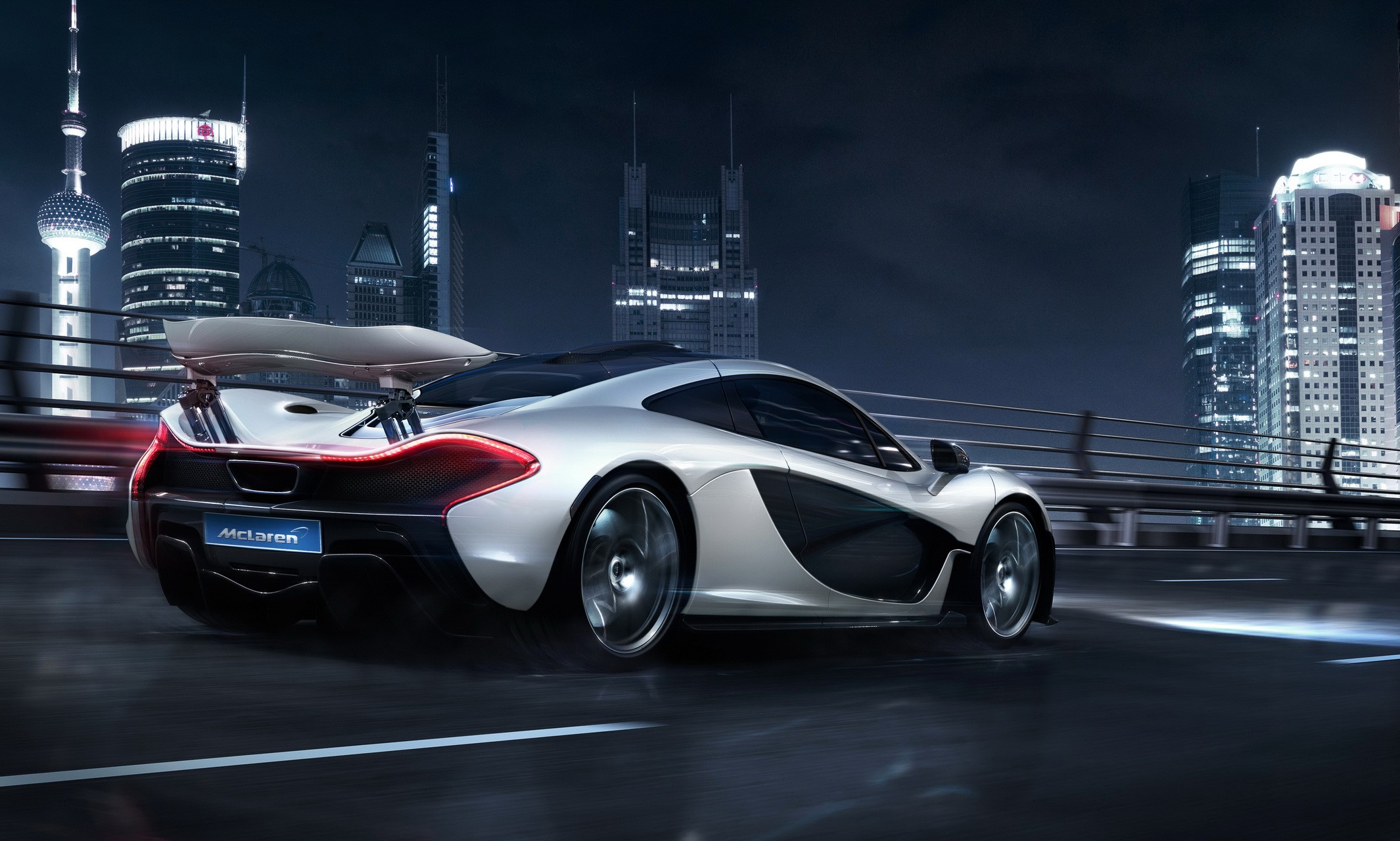 Silver McLaren P1 driving at night in a city HD Wallpaper
