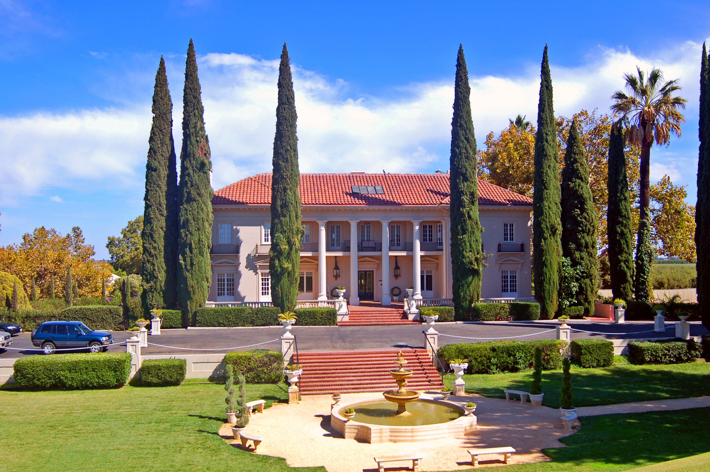 Mansion with cypress trees and fountain HD Wallpaper