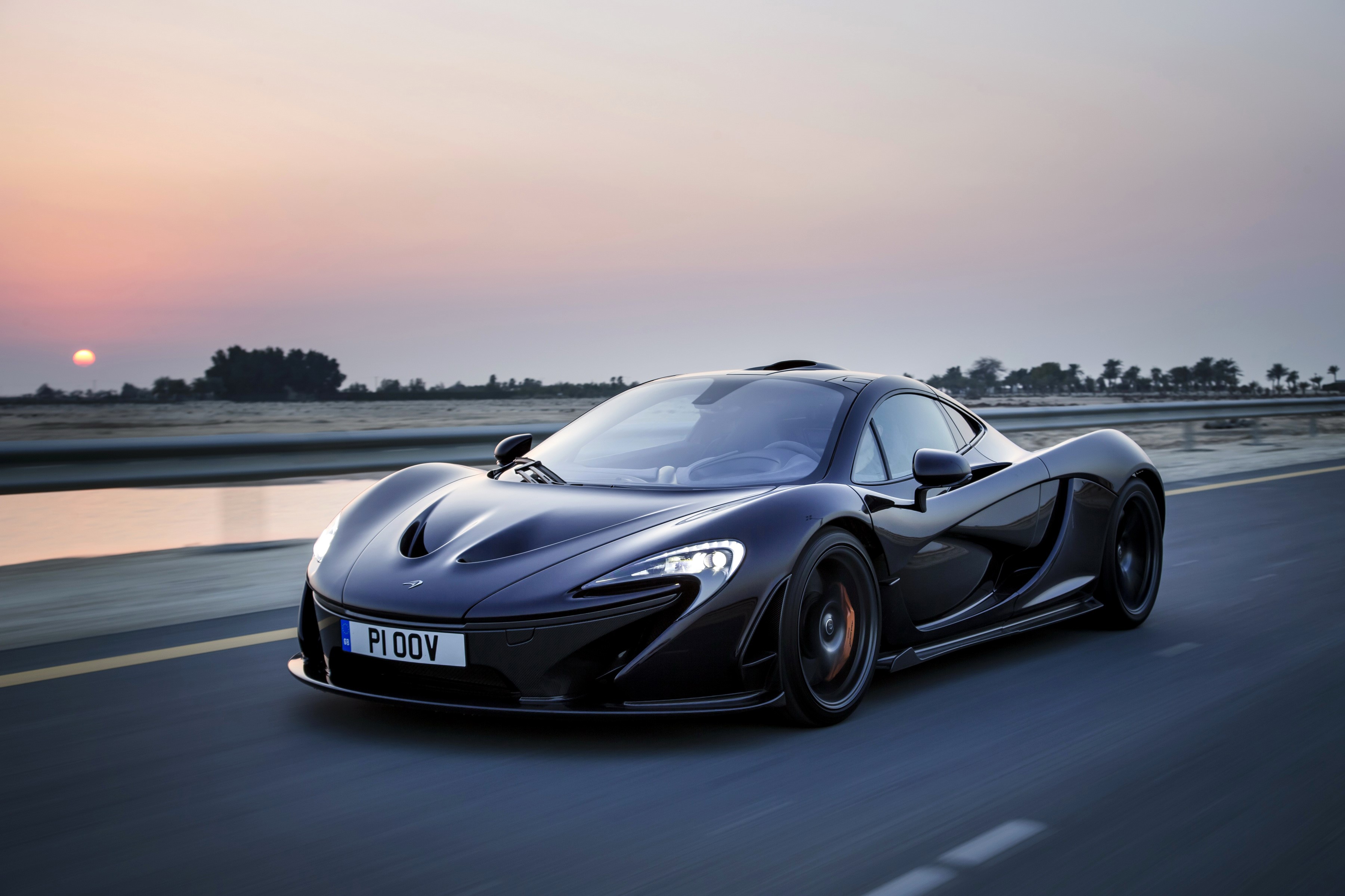 Black McLaren P1 driving at sunset HD Wallpaper