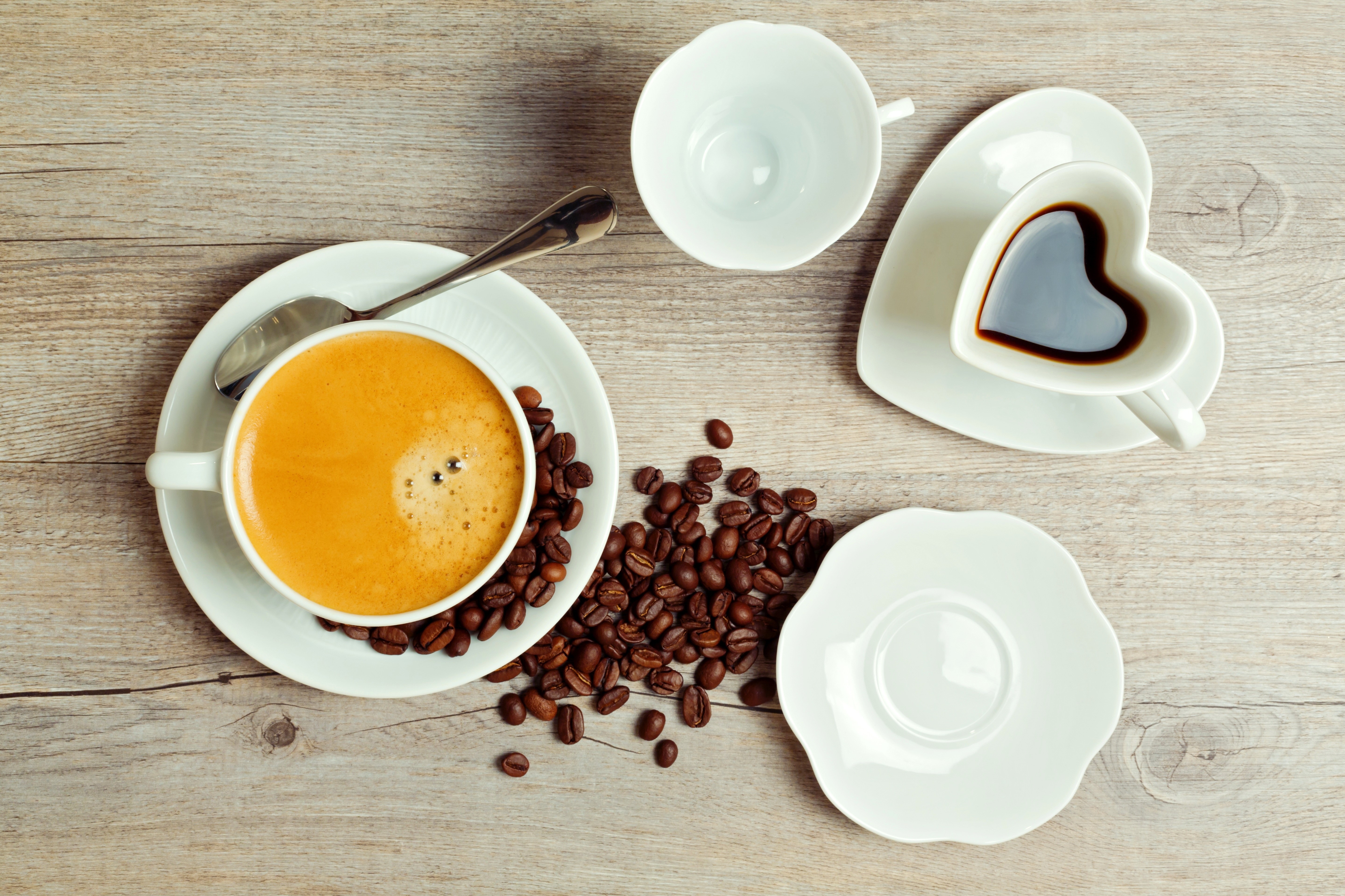 Coffee cups and beans on a wooden table HD Wallpaper