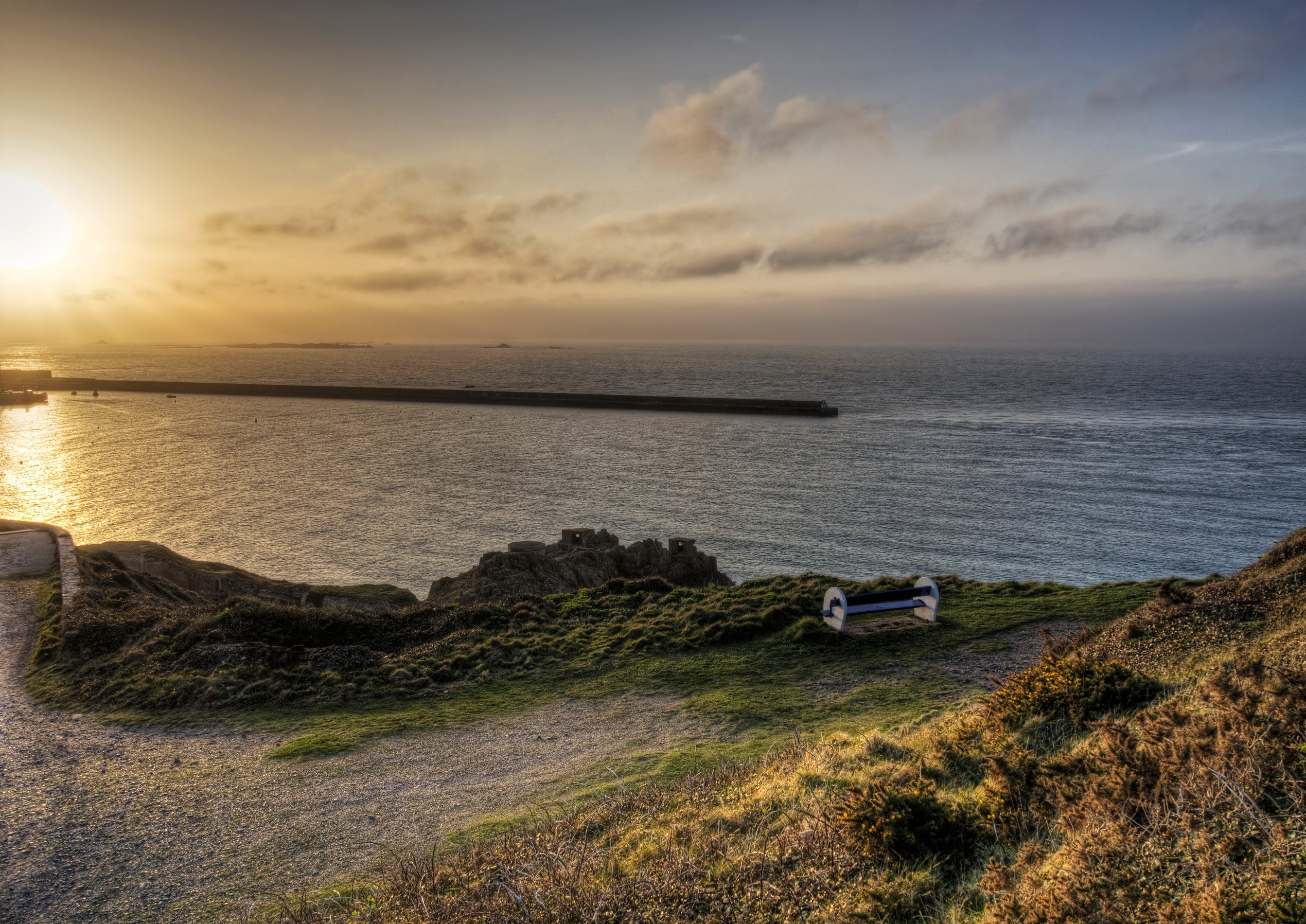 Alderney coast with a breakwater at sunset HD Wallpaper