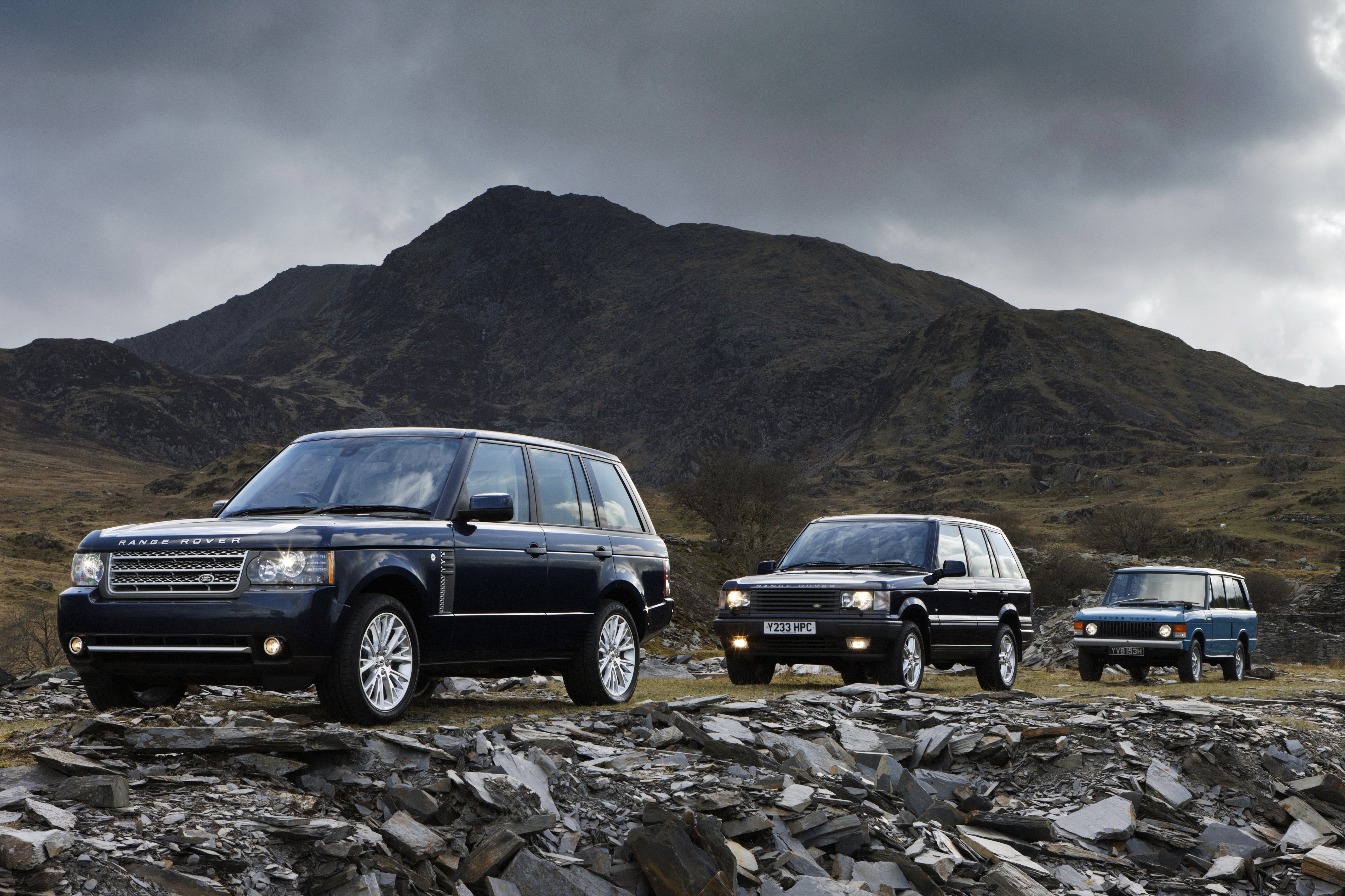 Three Range Rovers in a Mountainous Landscape HD Wallpaper