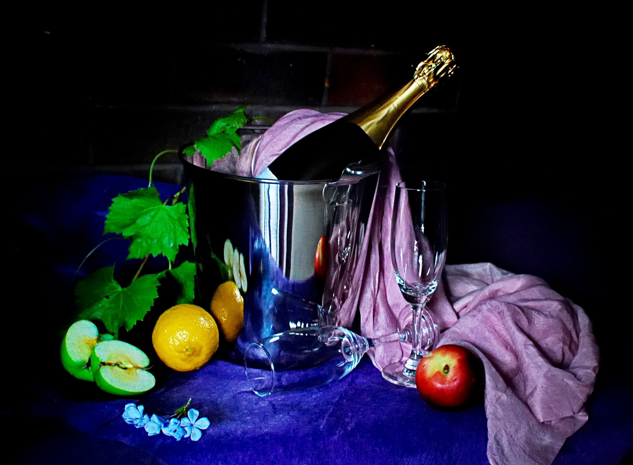Champagne bottle in ice bucket with fruit and stemware HD Wallpaper