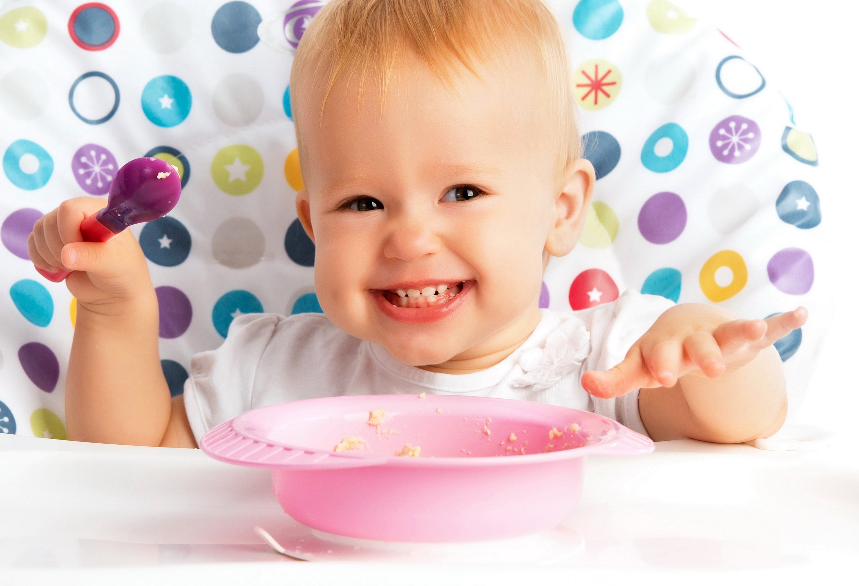 Baby holding a spoon with a pink bowl HD Wallpaper