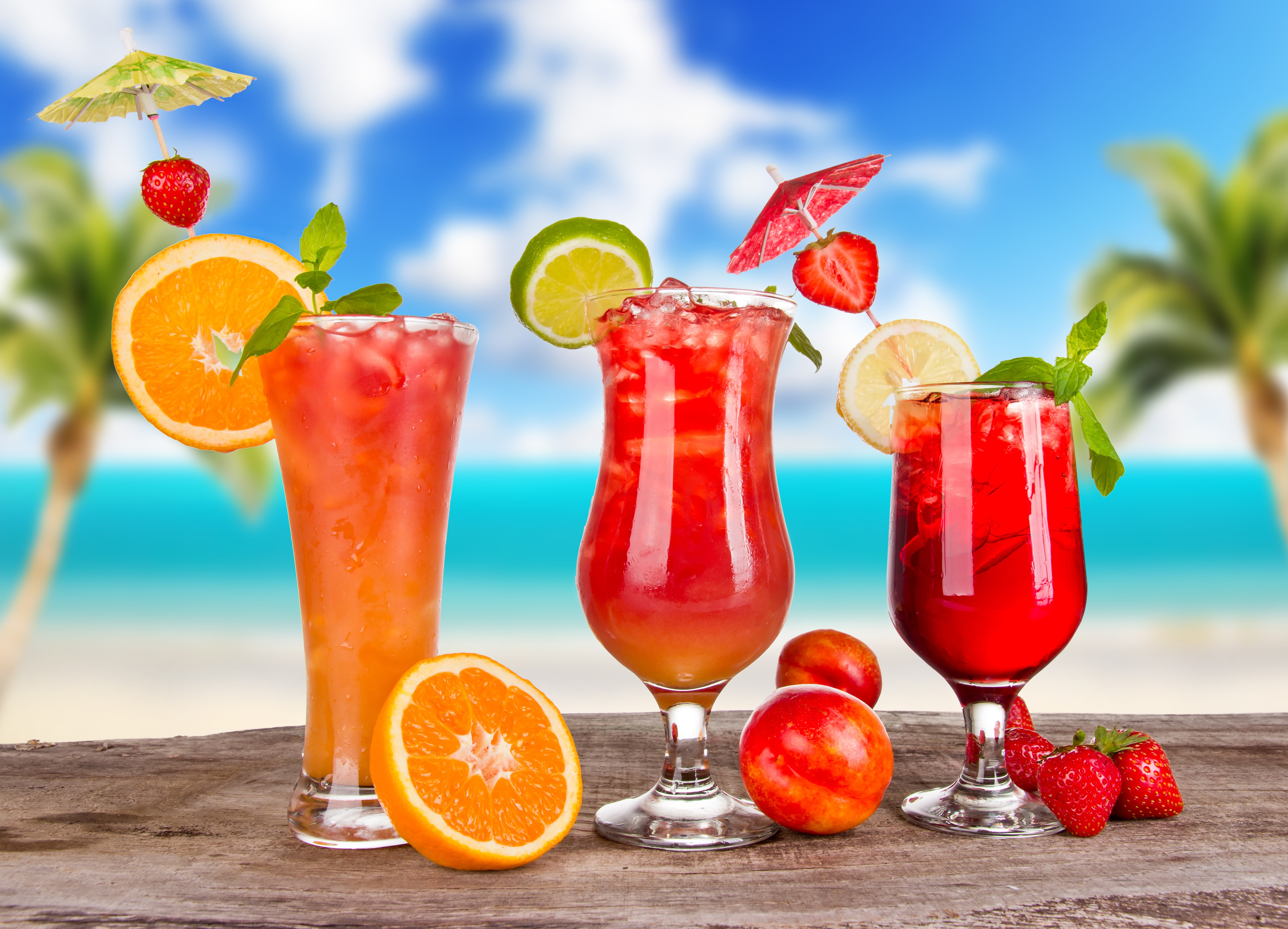 Tropical Cocktails with Fruit on a Beach Background HD Wallpaper