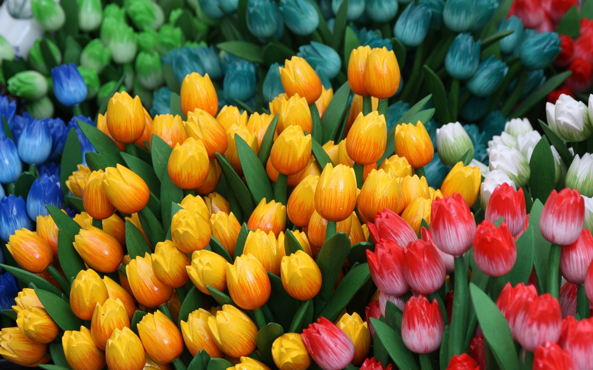 A colorful display of wooden tulips HD Wallpaper